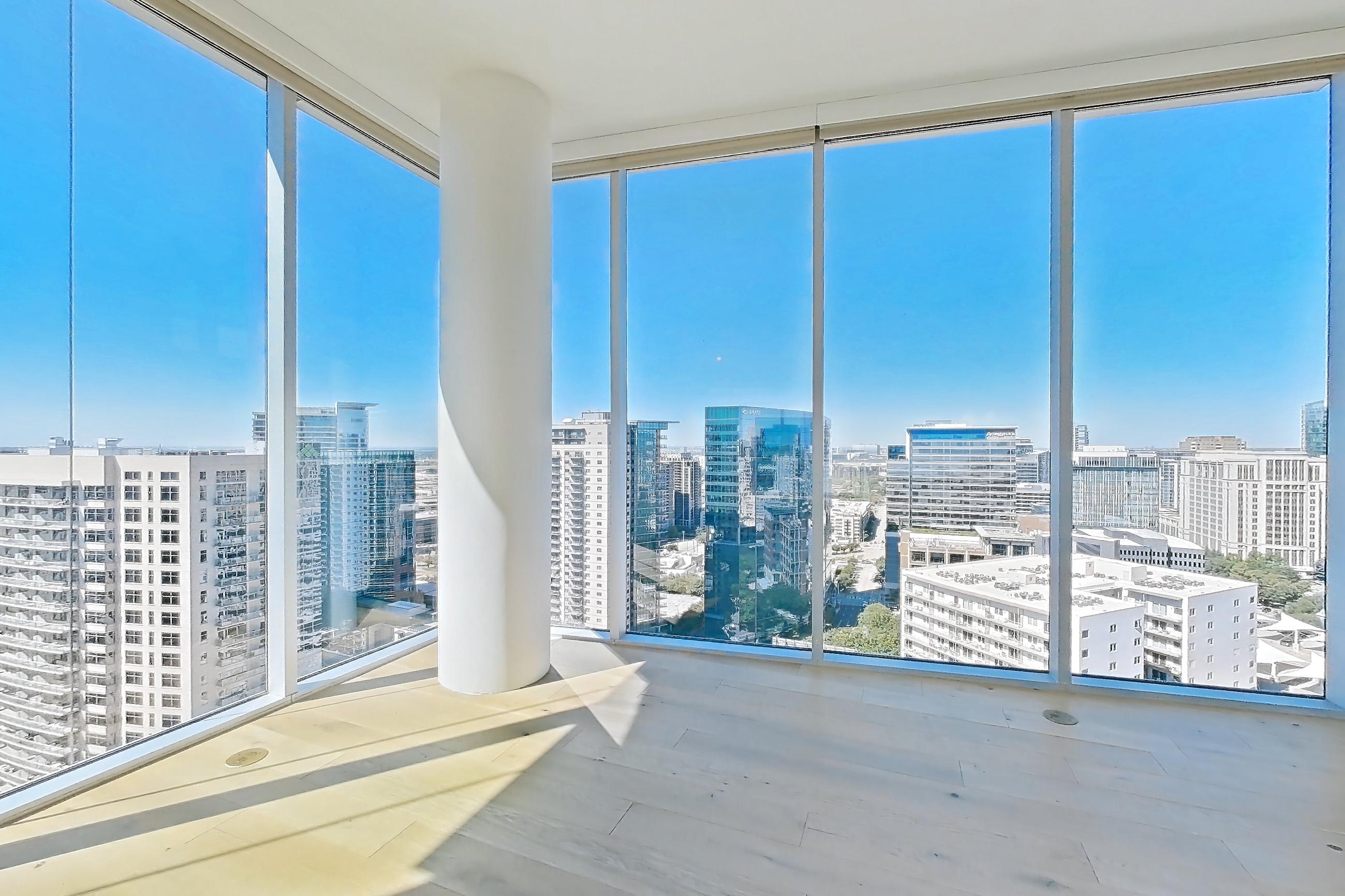 Living room with city view, refrigerator, and stainless steel appliances, Apartment 2701 at Cortland on McKinney
