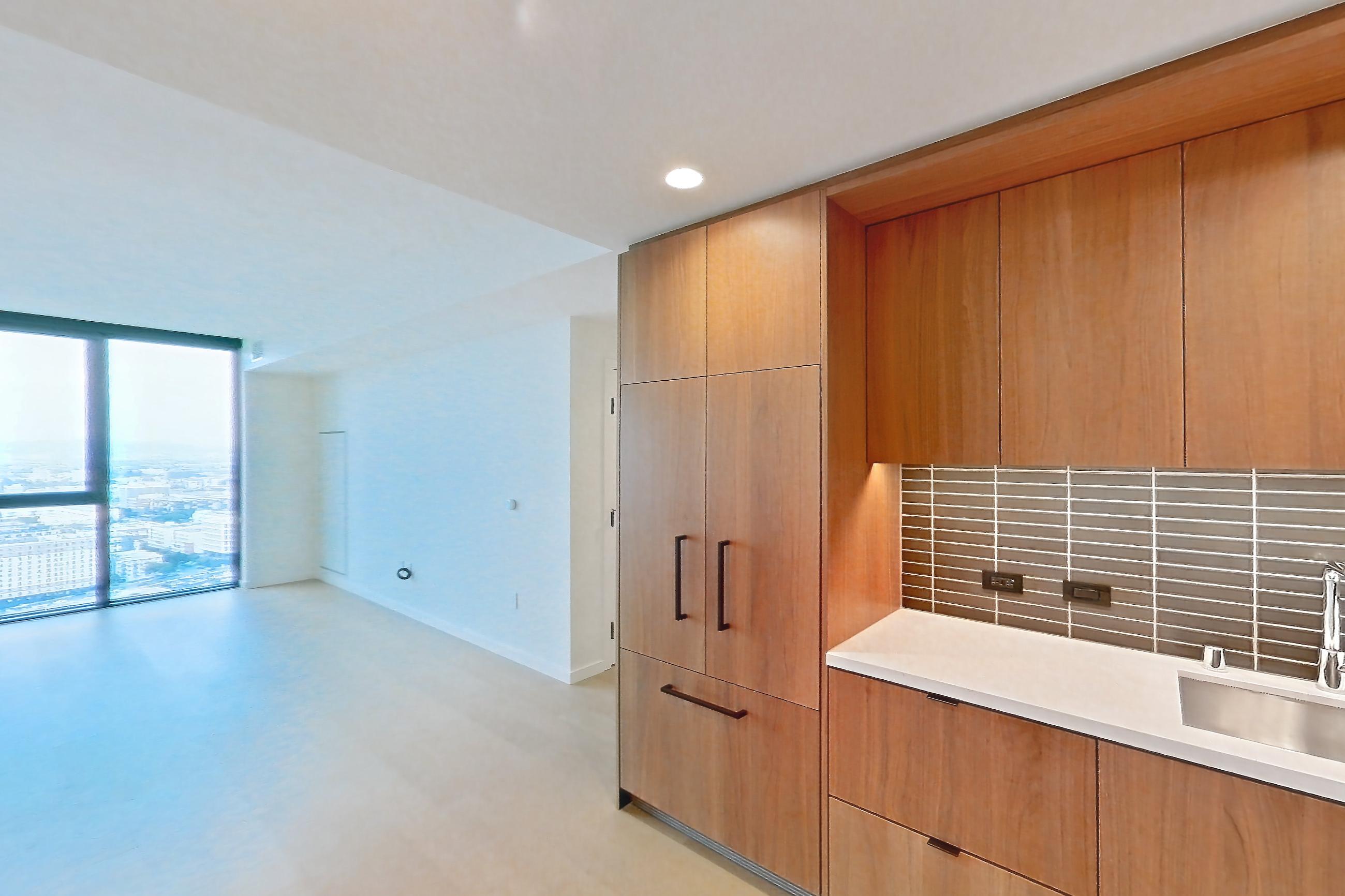 Kitchen with gas range, light stone countertops, light wood-finish flooring, oven/range, and stainless steel appliances, Apartment B-3004 at Beaudry