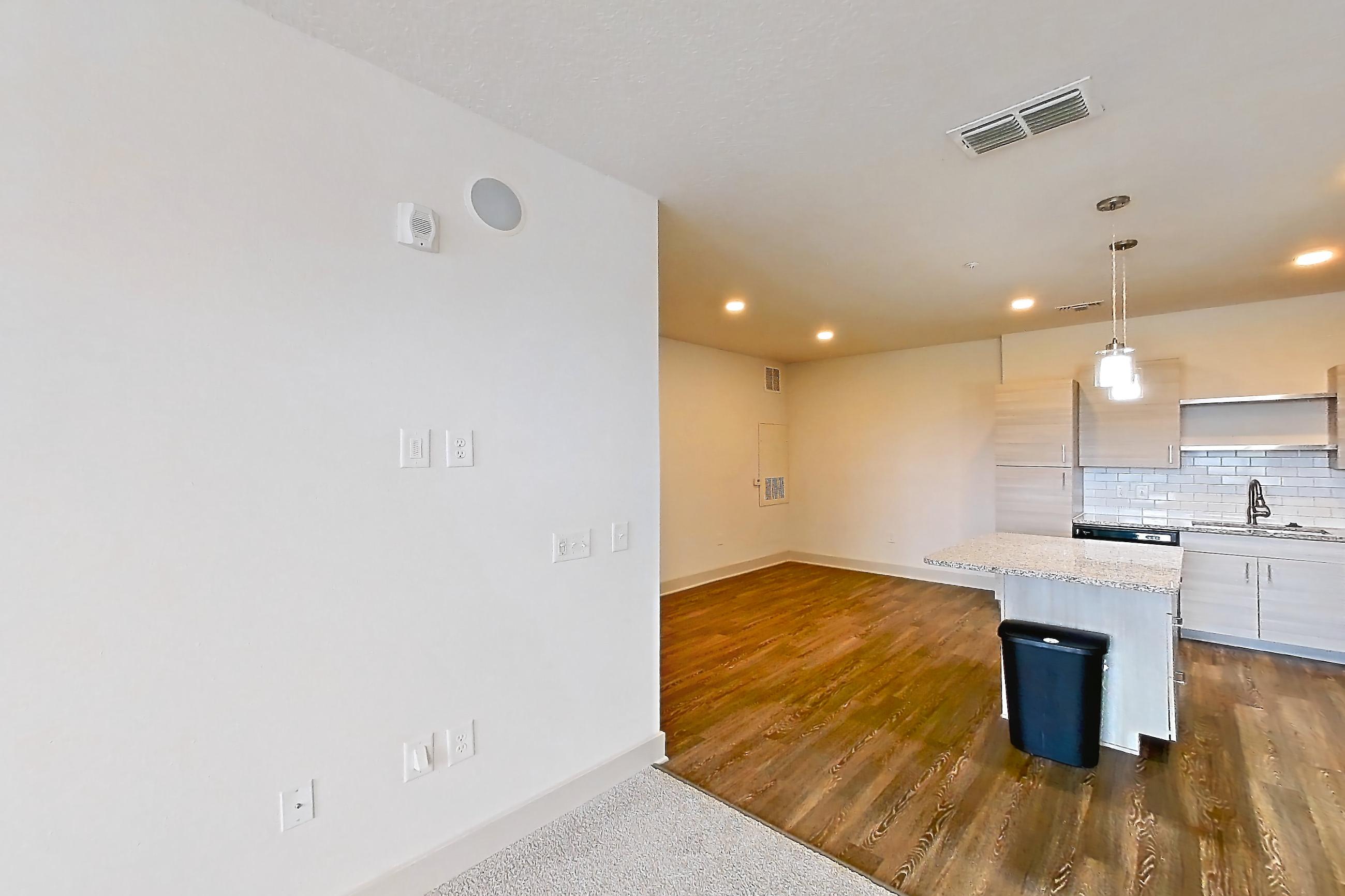 Living room with cooktop, light carpet, refrigerator, stainless steel appliances, and white appliances, Apartment 144-202 at Domain