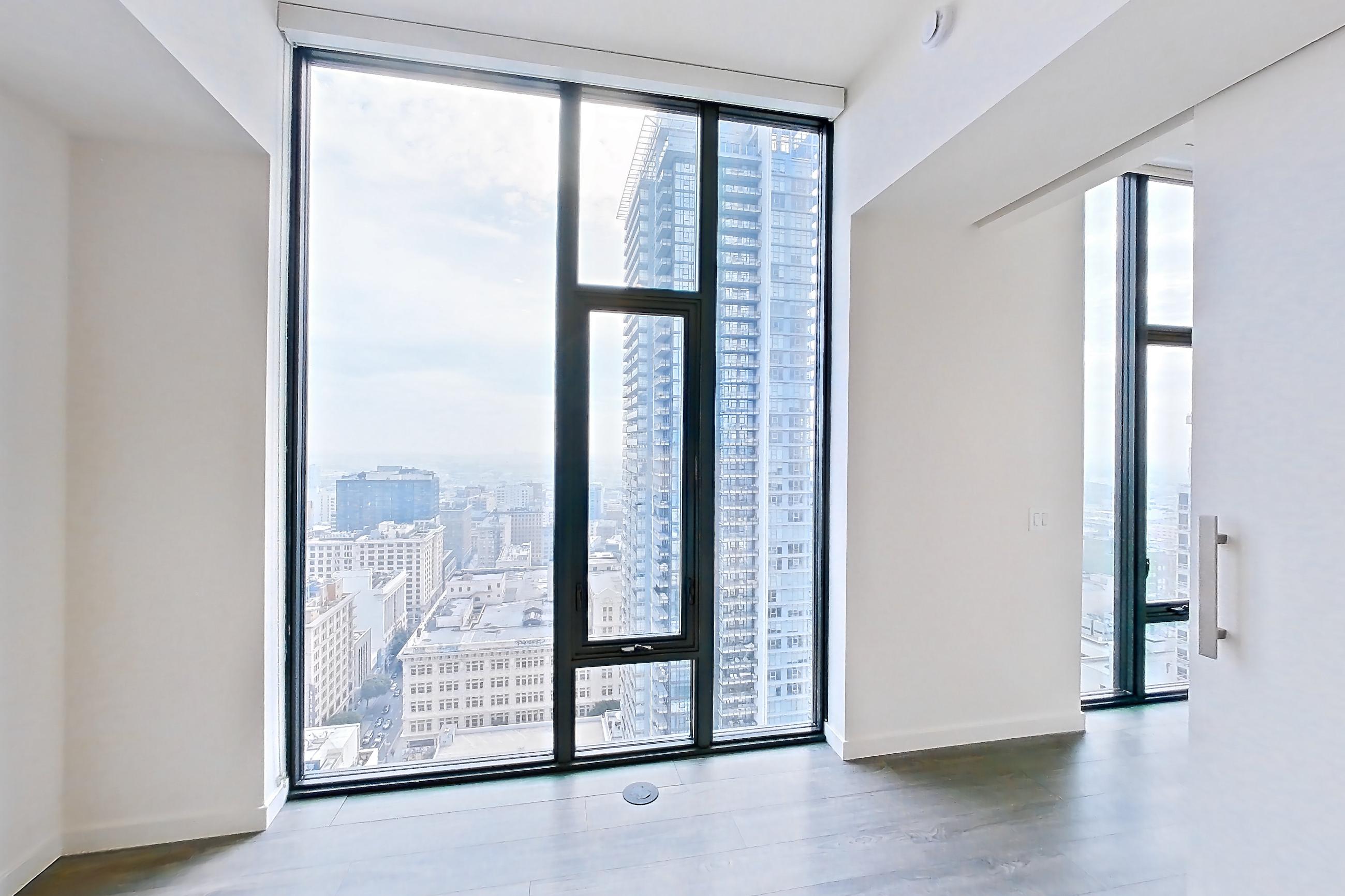 Living room with city view, dark wood-finish flooring, and light stone countertops, Apartment 3209 at Atelier