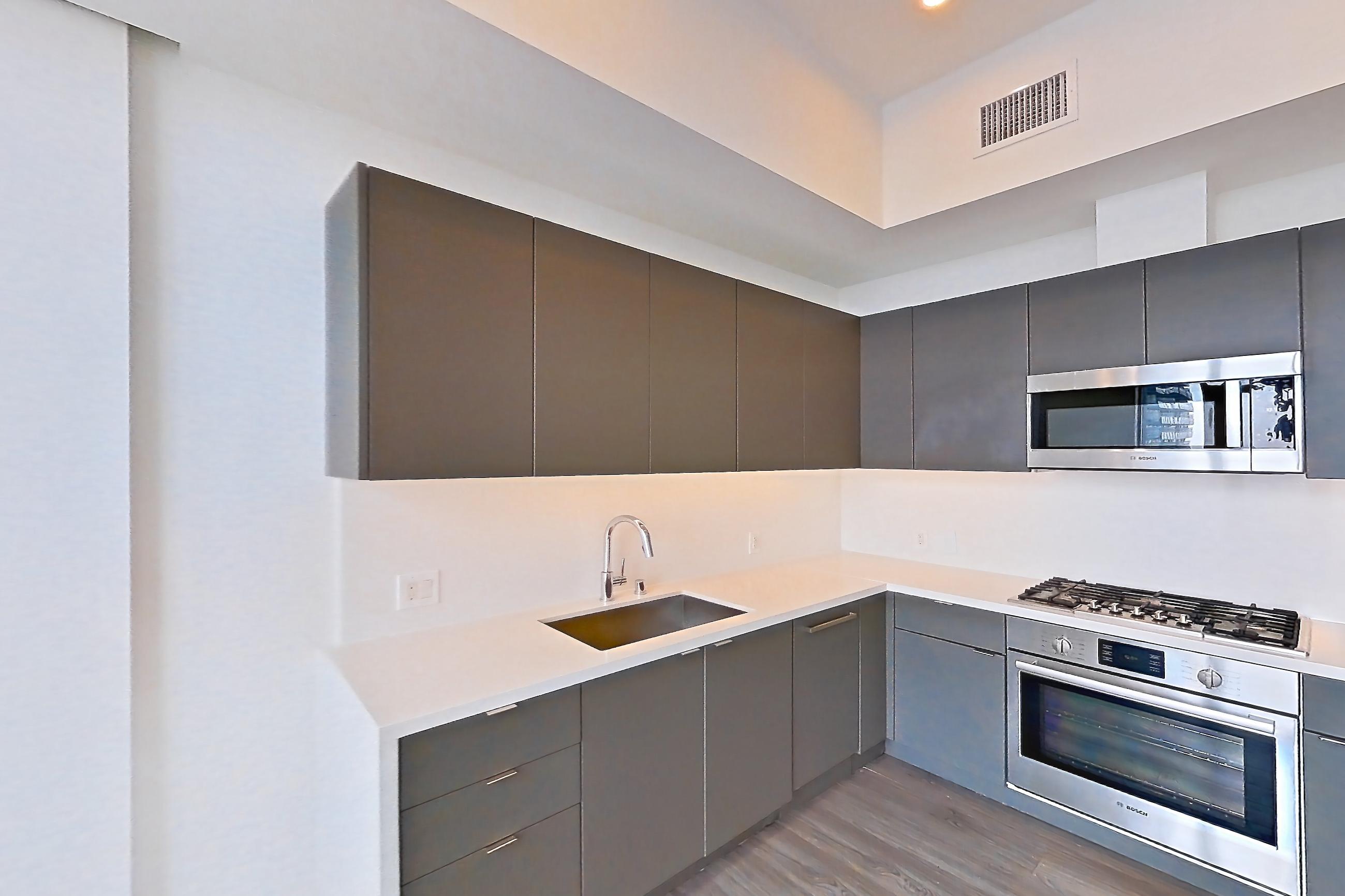 Living room with city view, dark wood-finish flooring, and light stone countertops, Apartment 3209 at Atelier