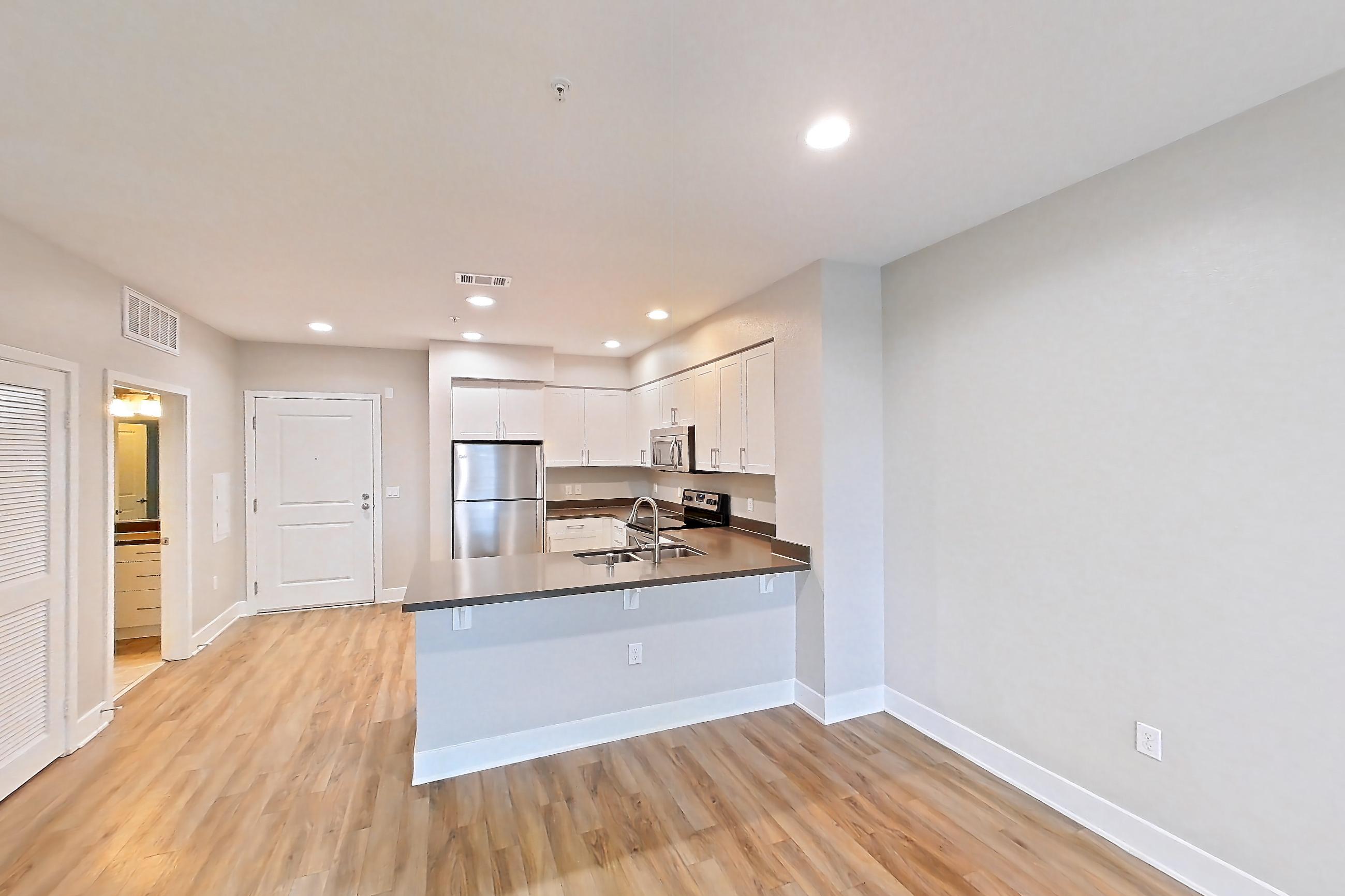Living room with light wood-finish flooring and wood-finish flooring, Apartment 0-3052 at Alder