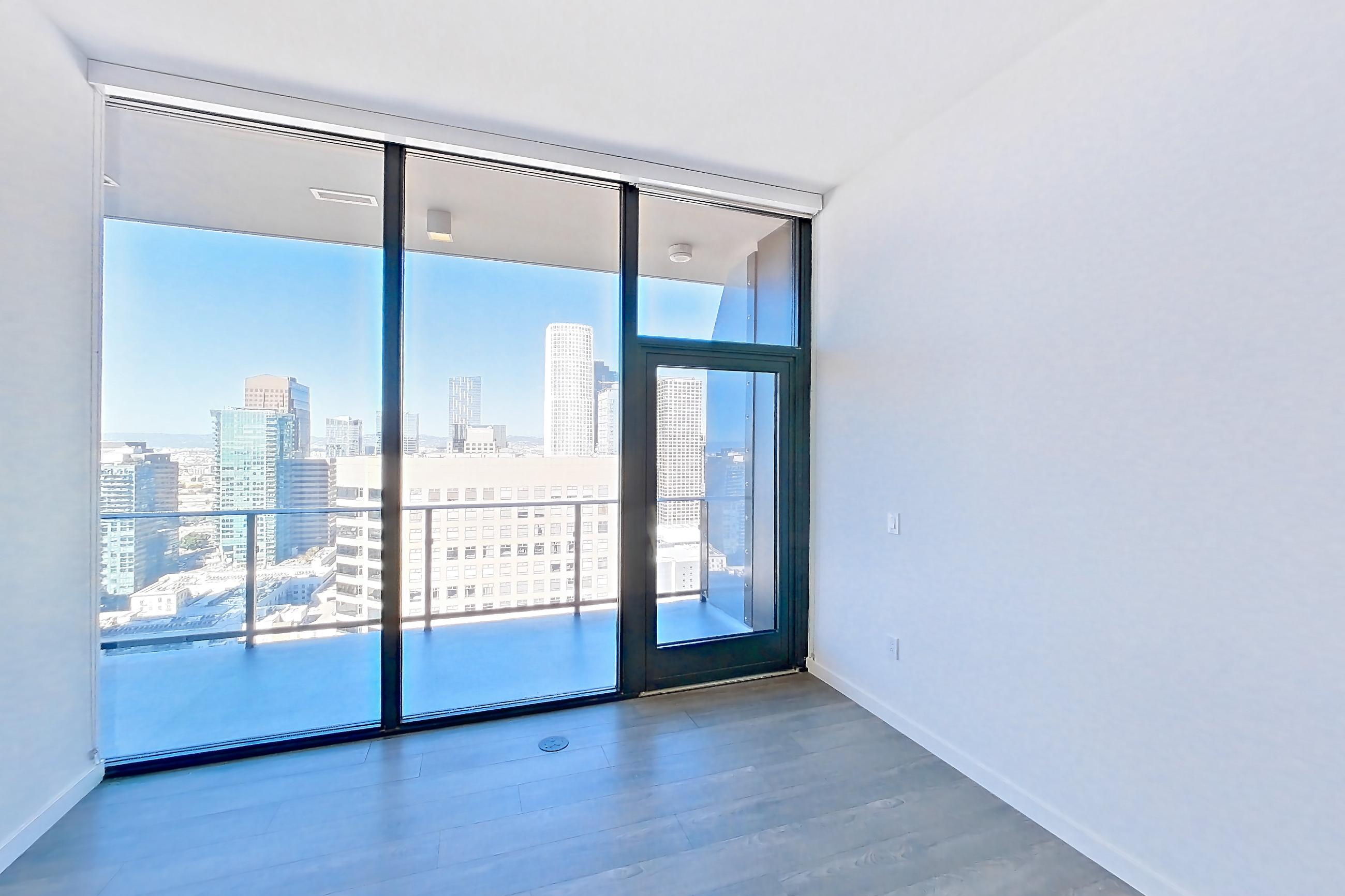 Living room with city view and dark wood-finish flooring, Apartment 3210 at Atelier