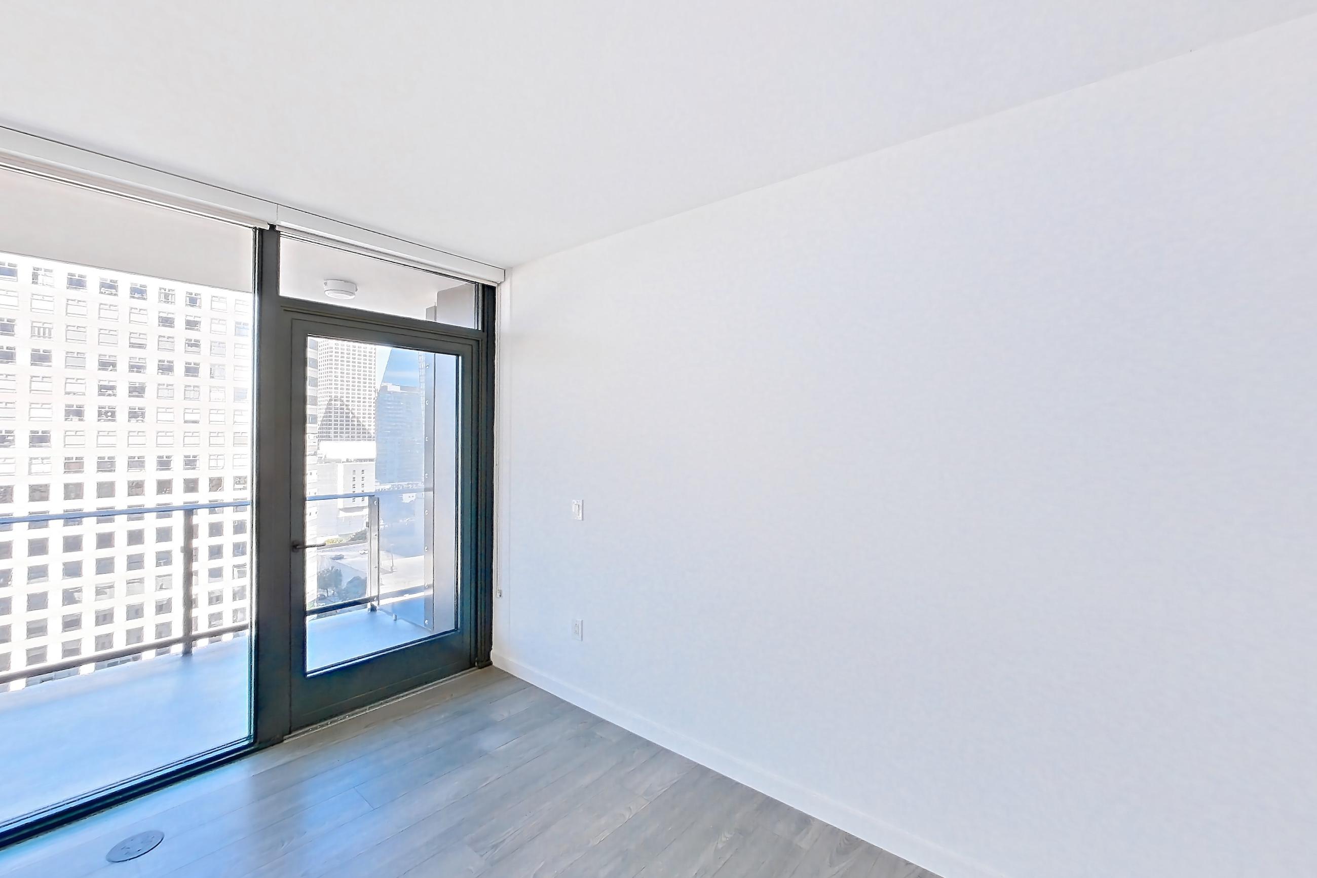 Living room with city view, dark wood-finish flooring, light stone countertops, and light wood-finish flooring, Apartment 1712 at Atelier