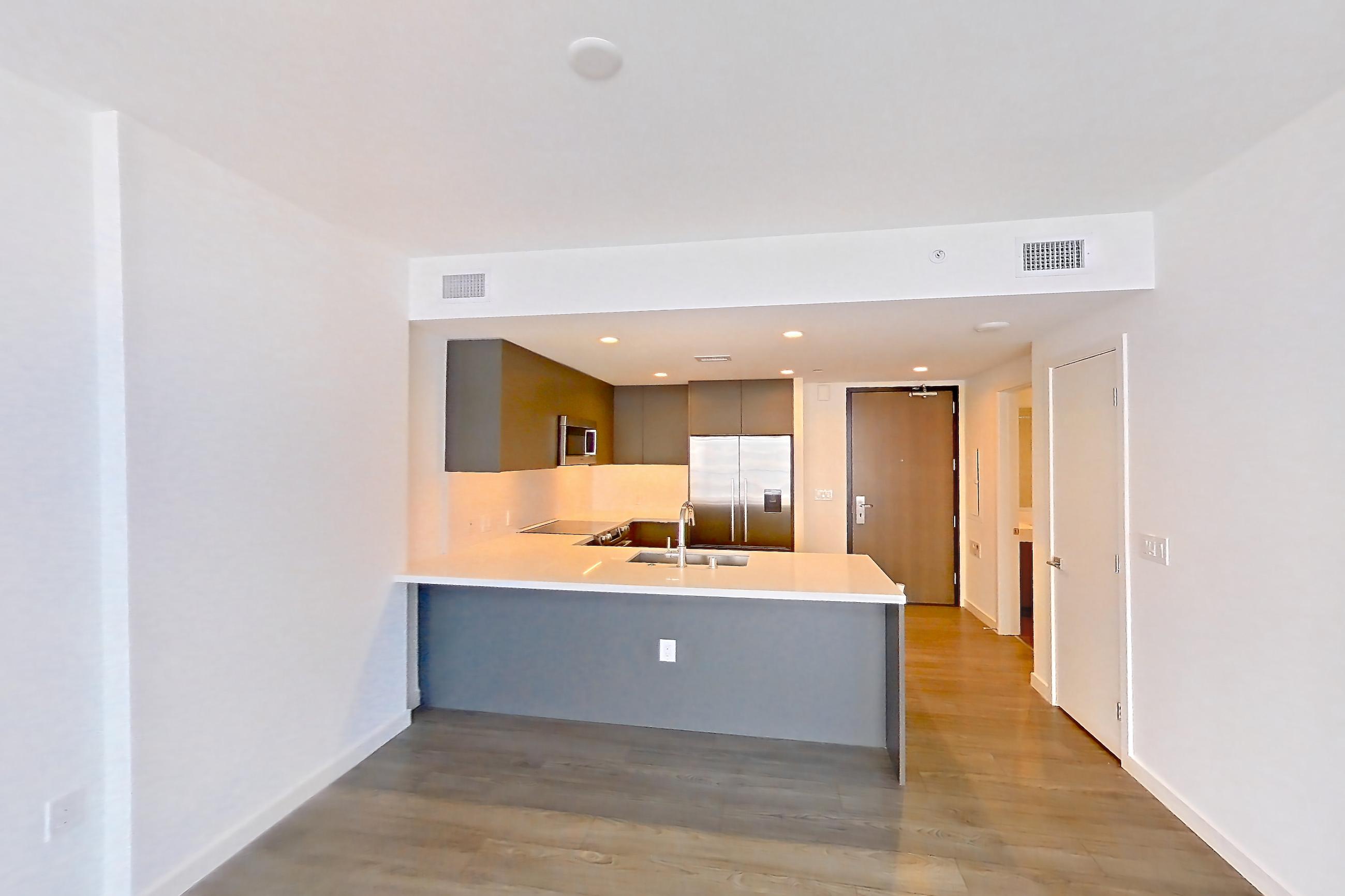 Living room with city view, dark wood-finish flooring, light stone countertops, and light wood-finish flooring, Apartment 1712 at Atelier