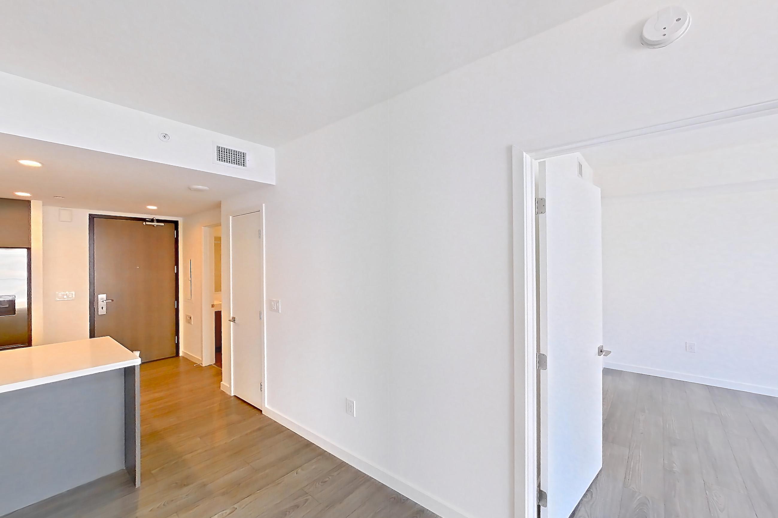Living room with city view, dark wood-finish flooring, light stone countertops, and light wood-finish flooring, Apartment 1712 at Atelier