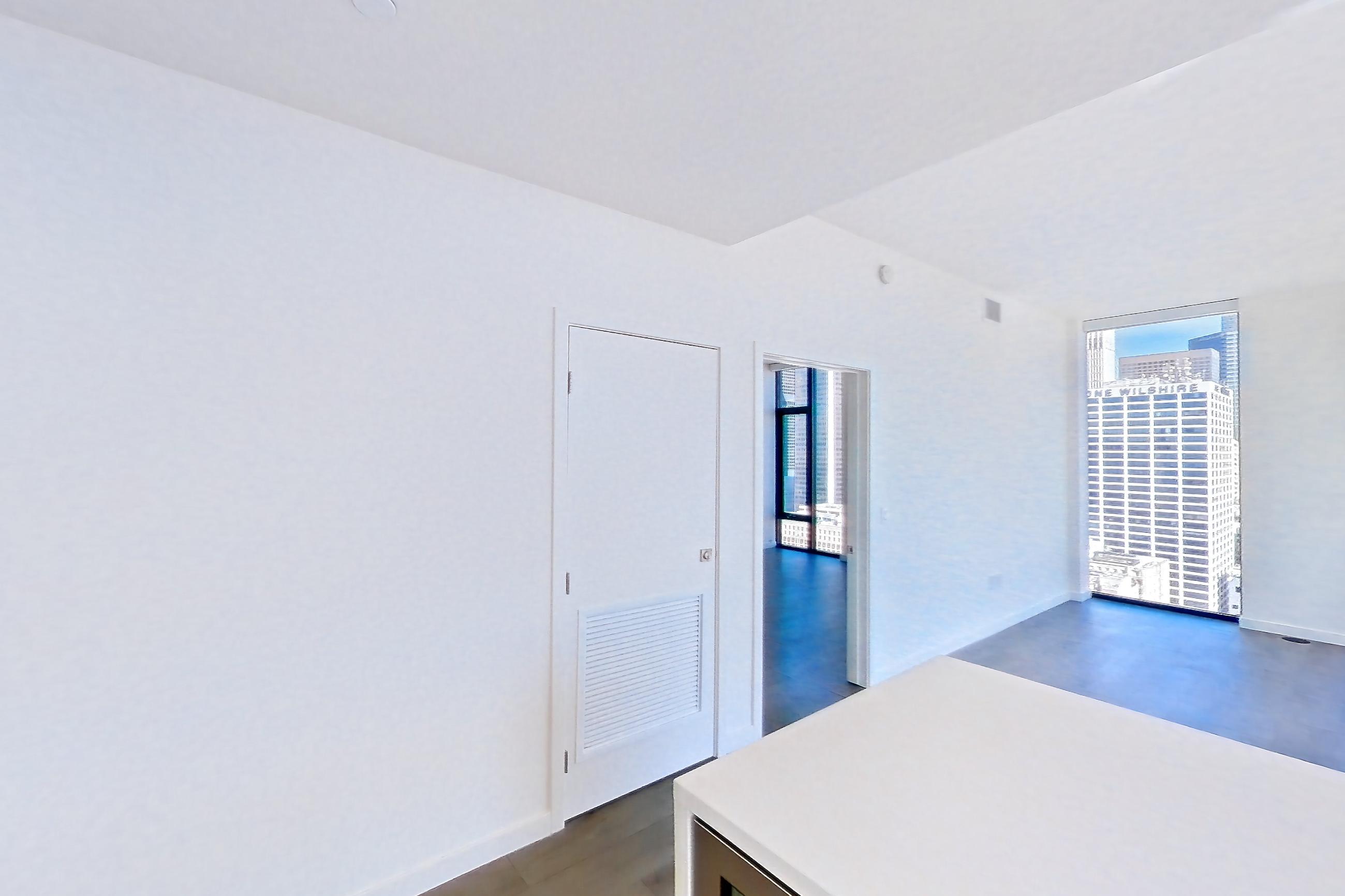 Kitchen with cooktop, dark wood-finish flooring, gas cooktop, light stone countertops, oven/range, stainless steel appliances, and wood-finish flooring, Apartment 3001 at Atelier