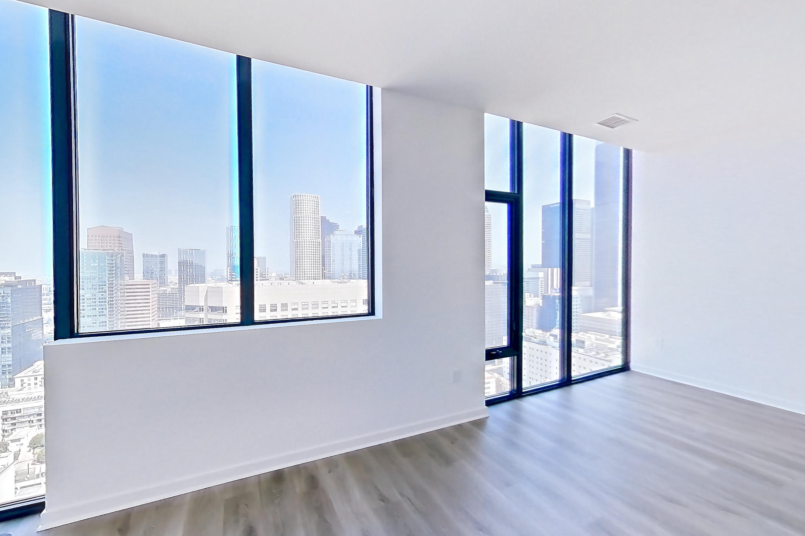 Living room with dark wood-finish flooring, Apartment PH08 at Atelier