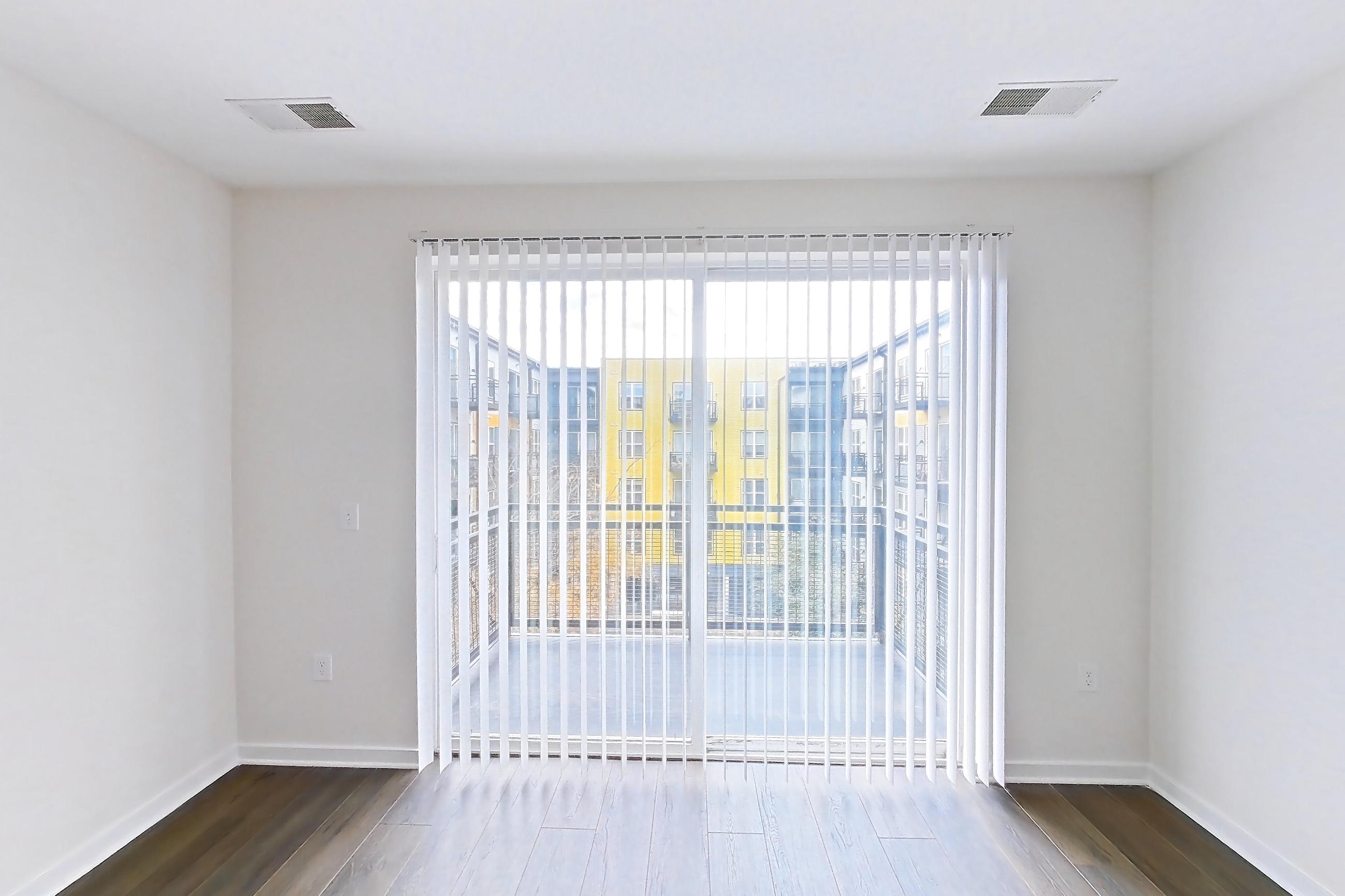 Living room with dark wood-finish flooring, Apartment 1-421 at The Parker at Huntington Metro
