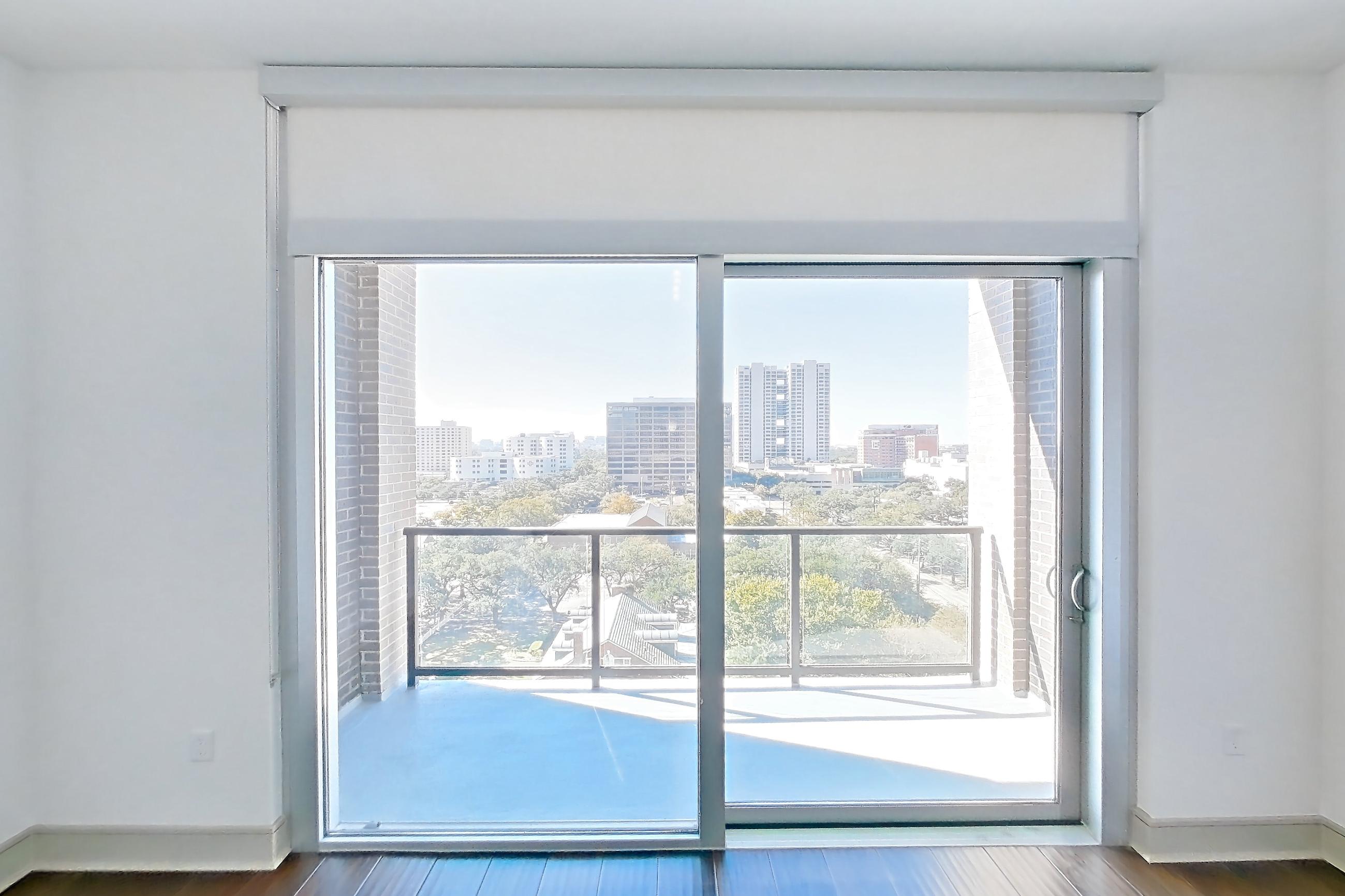 Living room with dark wood-finish flooring, Apartment 1007 at Cortland Museum District