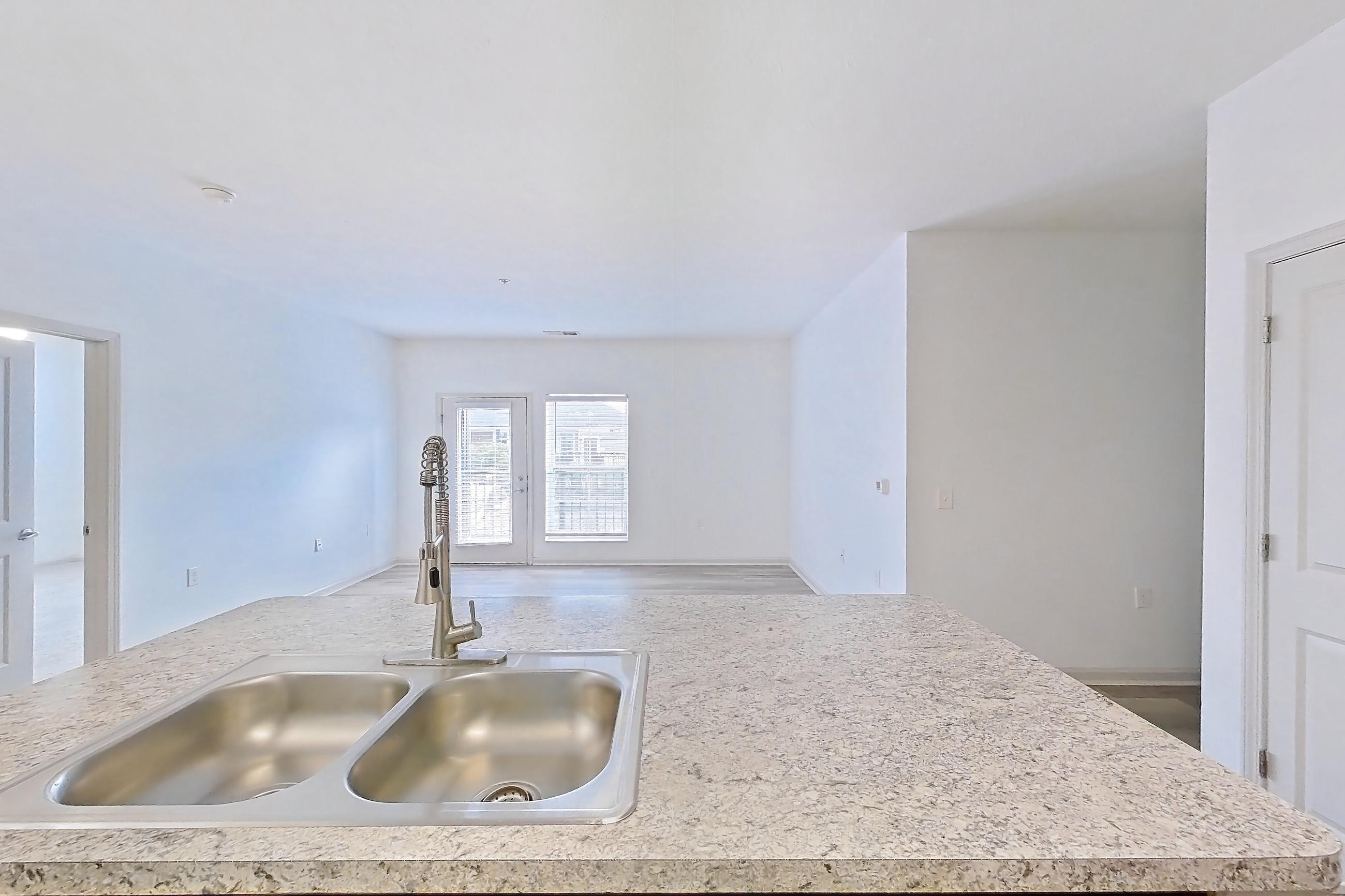 Kitchen with dishwasher, electric range, light countertops, light wood-finish flooring, microwave, oven/range, refrigerator, and stainless steel appliances, Apartment 105-4808 at Cortland Hilliard