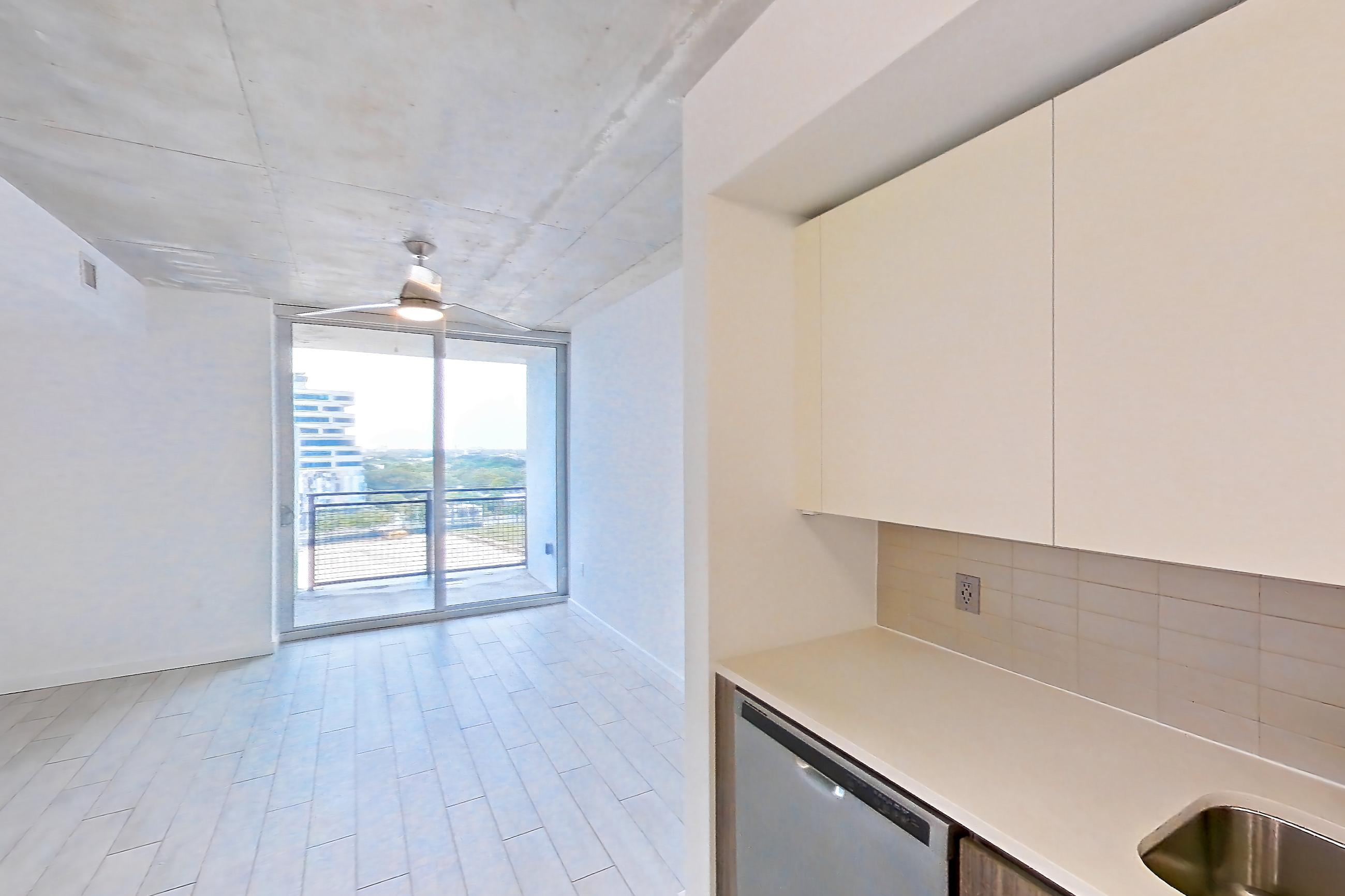 Kitchen with dishwasher, electric range, light countertops, light tile flooring, light wood-finish flooring, microwave, oven/range, refrigerator, stainless steel appliances, water & ice dispenser, and wood-look tile flooring, Apartment 1016 at Cortland Midtown Miami