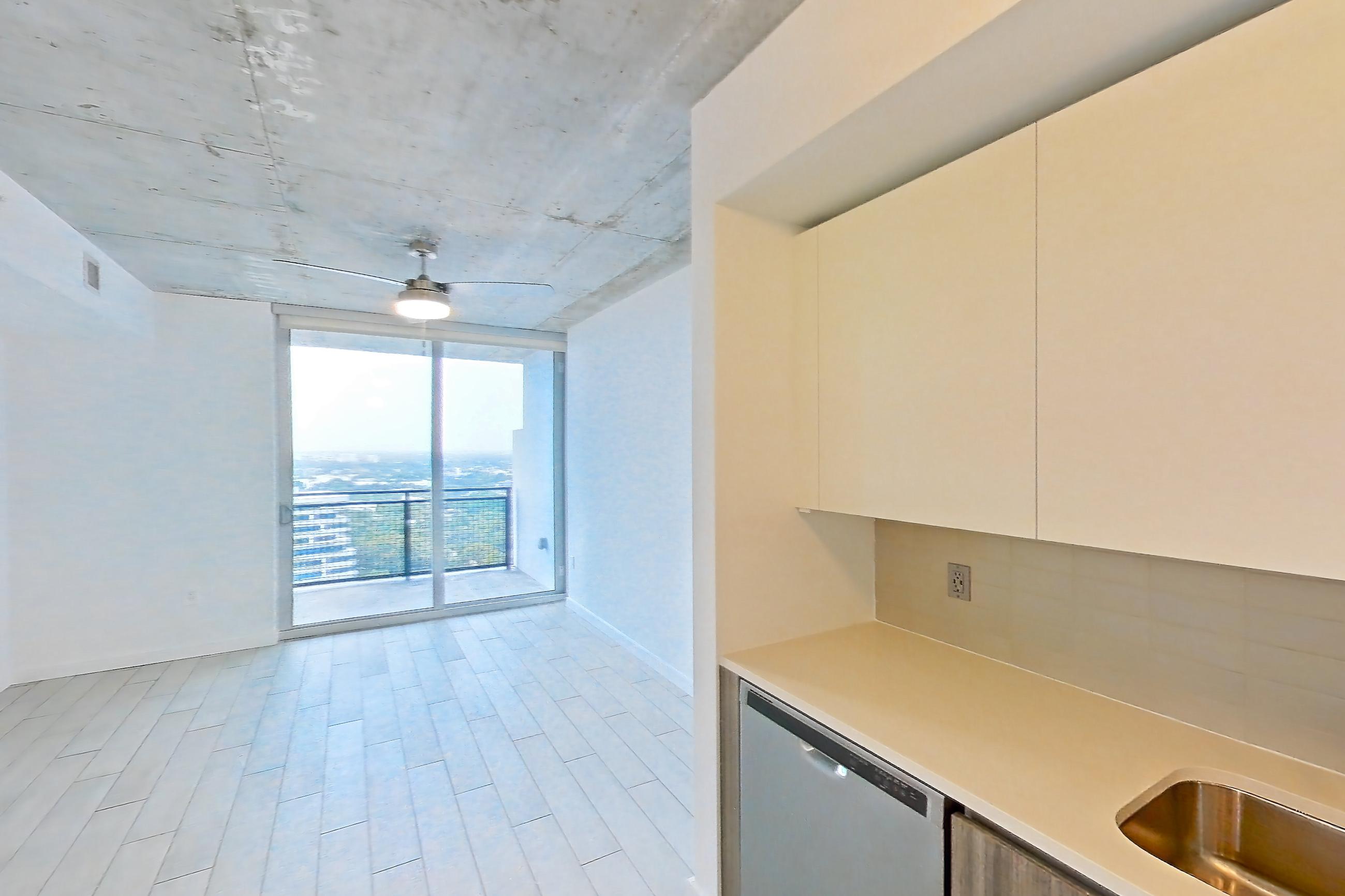 Kitchen with dishwasher, electric range, light countertops, light tile flooring, light wood-finish flooring, microwave, oven/range, refrigerator, stainless steel appliances, water & ice dispenser, and wood-look tile flooring, Apartment 2416 at Cortland Midtown Miami