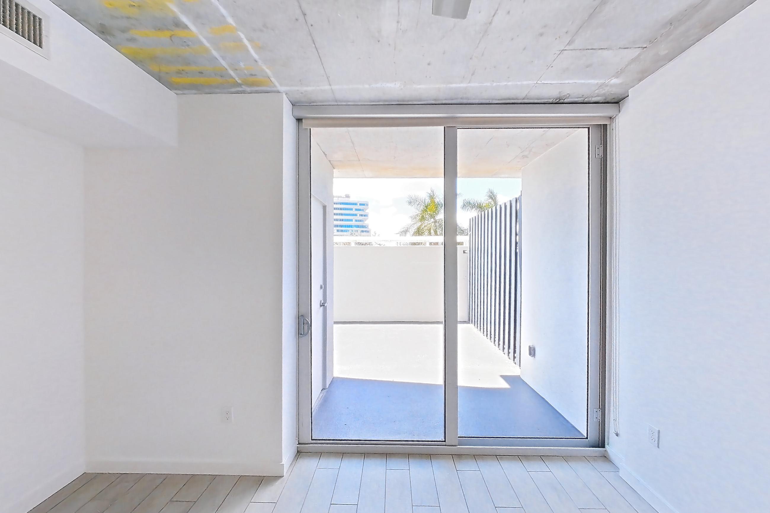 Living room with light wood-finish flooring and wood-look tile flooring, Apartment 0312 at Cortland Midtown Miami