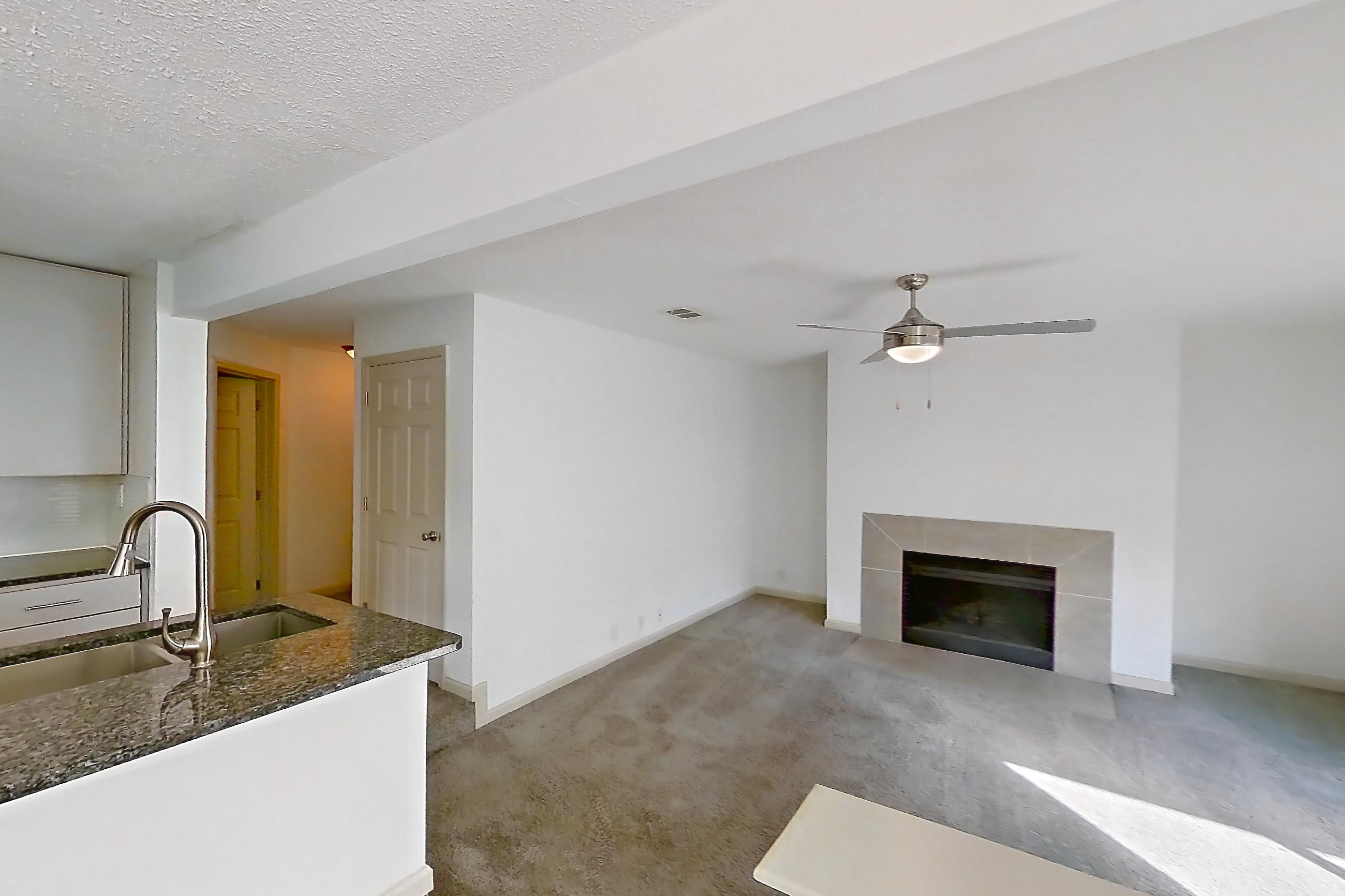 Dining room with dark stone countertops, electric range, fireplace, oven/range, stainless steel appliances, and tile fireplace, Apartment 8 at Cortland Cotswold