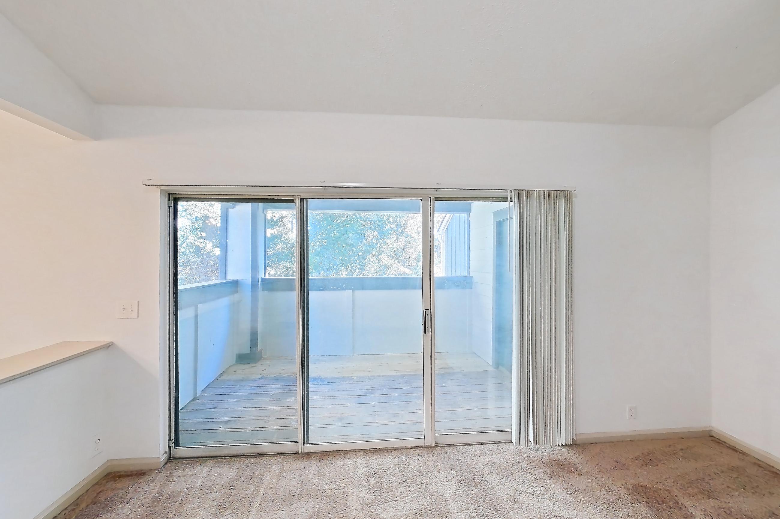 Living room with fireplace, light carpet, and tile fireplace, Apartment 11 at Cortland Cotswold