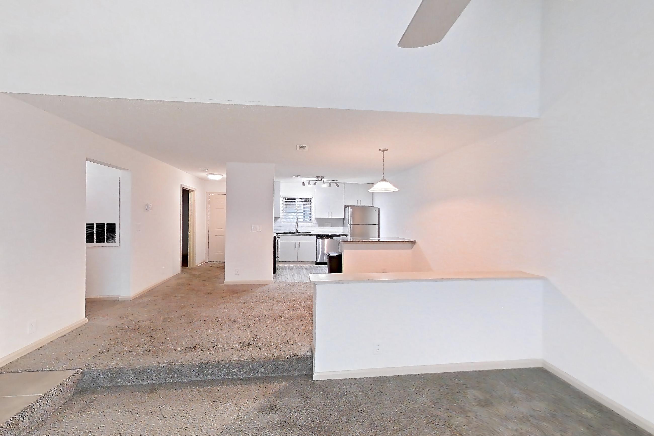 Living space with dishwasher, fireplace, stainless steel appliances, and tile fireplace, Apartment 9 at Cortland Cotswold