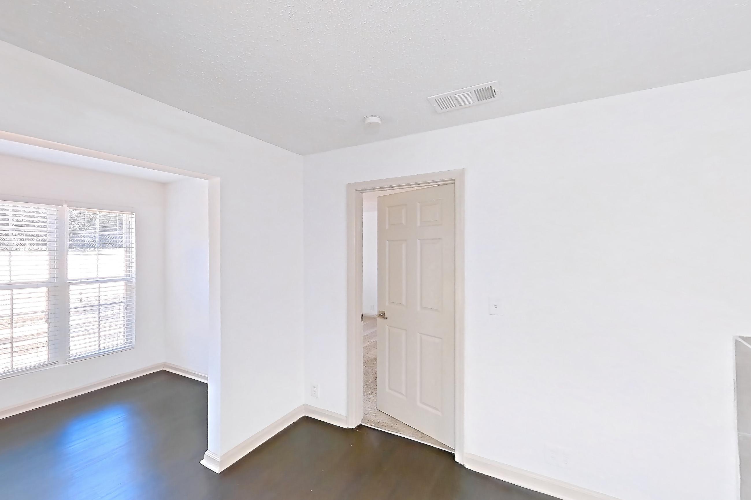 Living room with dark wood-finish flooring, fireplace, and tile fireplace, Apartment 3 at Cortland Cotswold