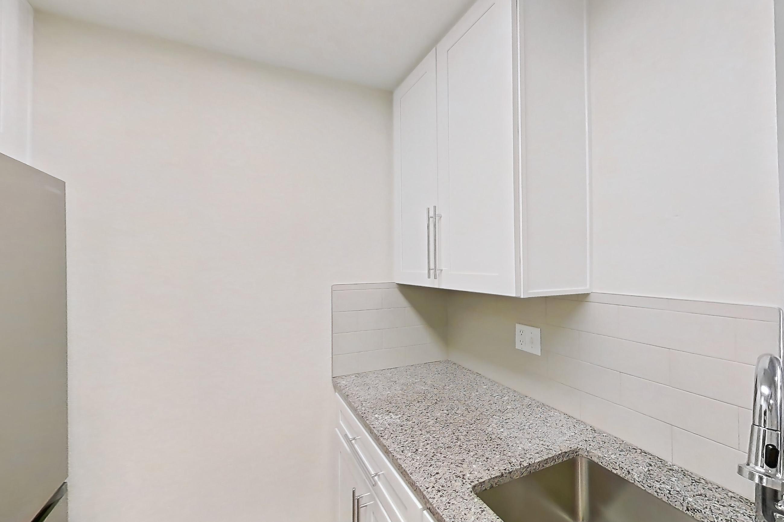 Kitchen with dishwasher, light countertops, light stone countertops, light wood-finish flooring, oven/range, refrigerator, and stainless steel appliances, Apartment 250 at Cortland Sun River