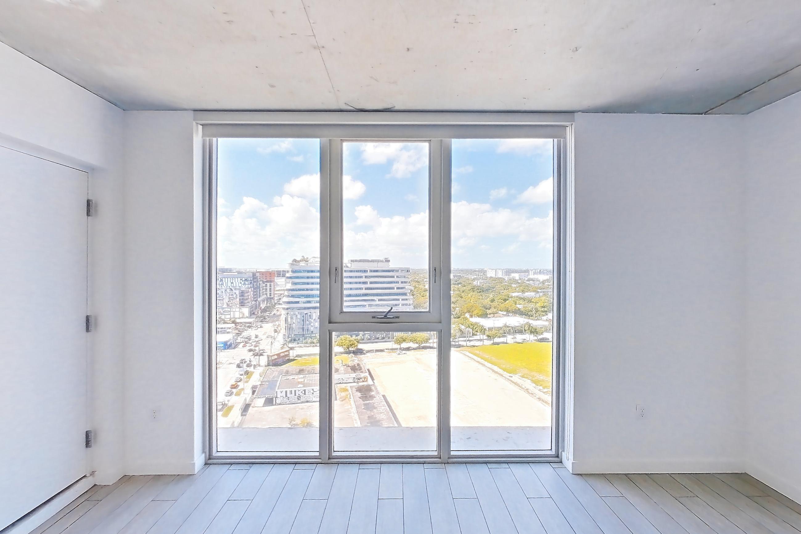 Living space with light wood-finish flooring and wood-look tile flooring, Apartment 1818 at Cortland Midtown Miami