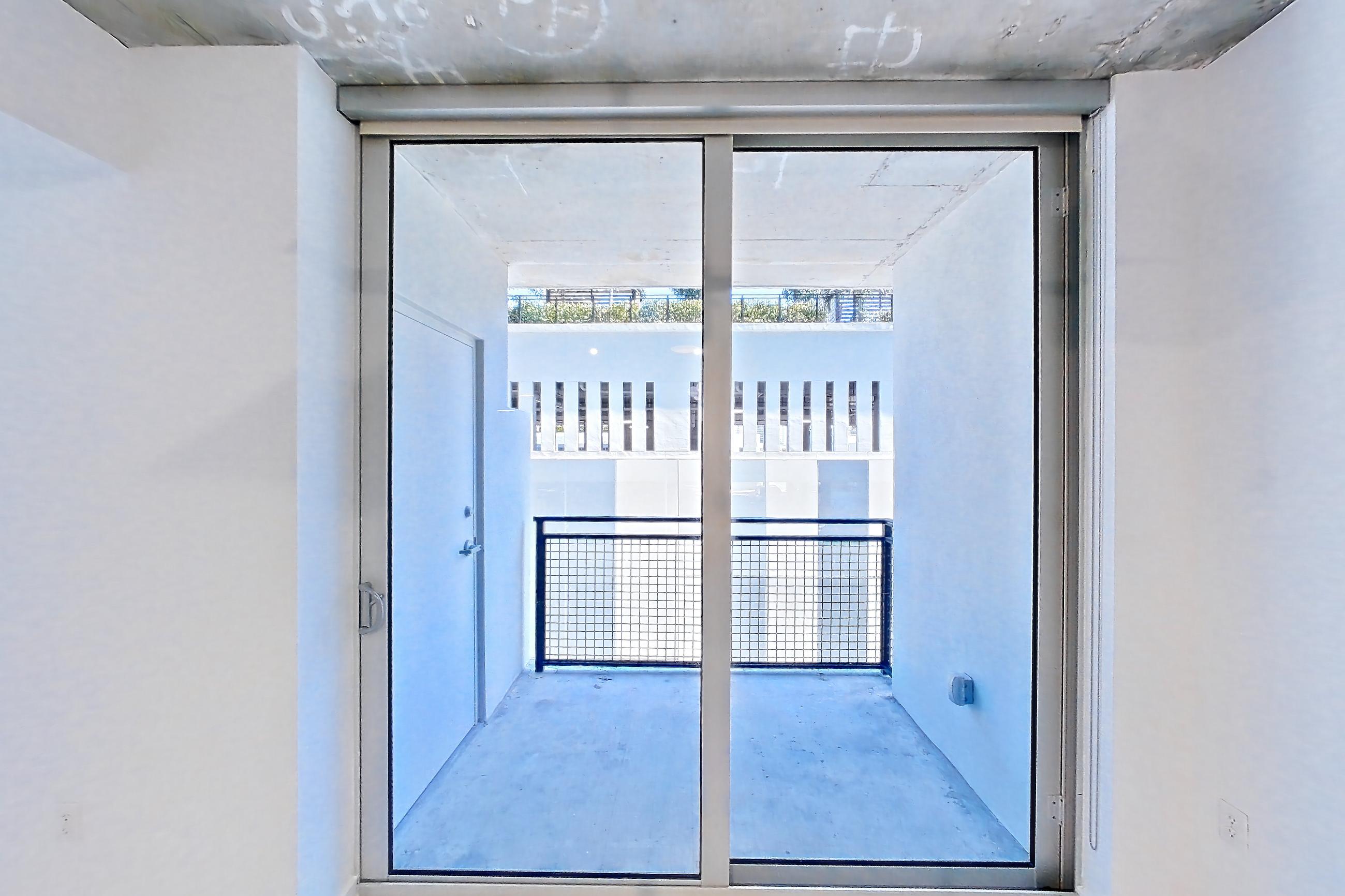 Living room with wood-look tile flooring, Apartment 0907 at Cortland Midtown Miami