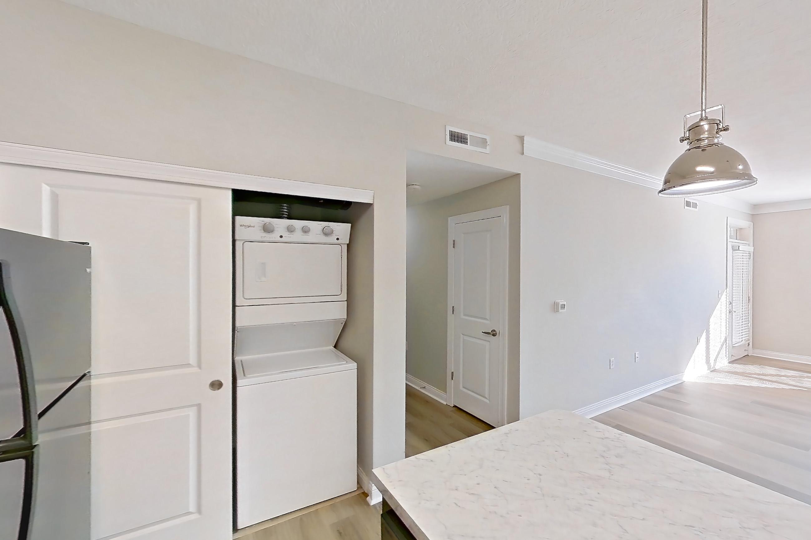 Kitchen with black appliances, electric range, light countertops, light wood-finish flooring, oven/range, and refrigerator, Apartment M265 at Cortland Northlake