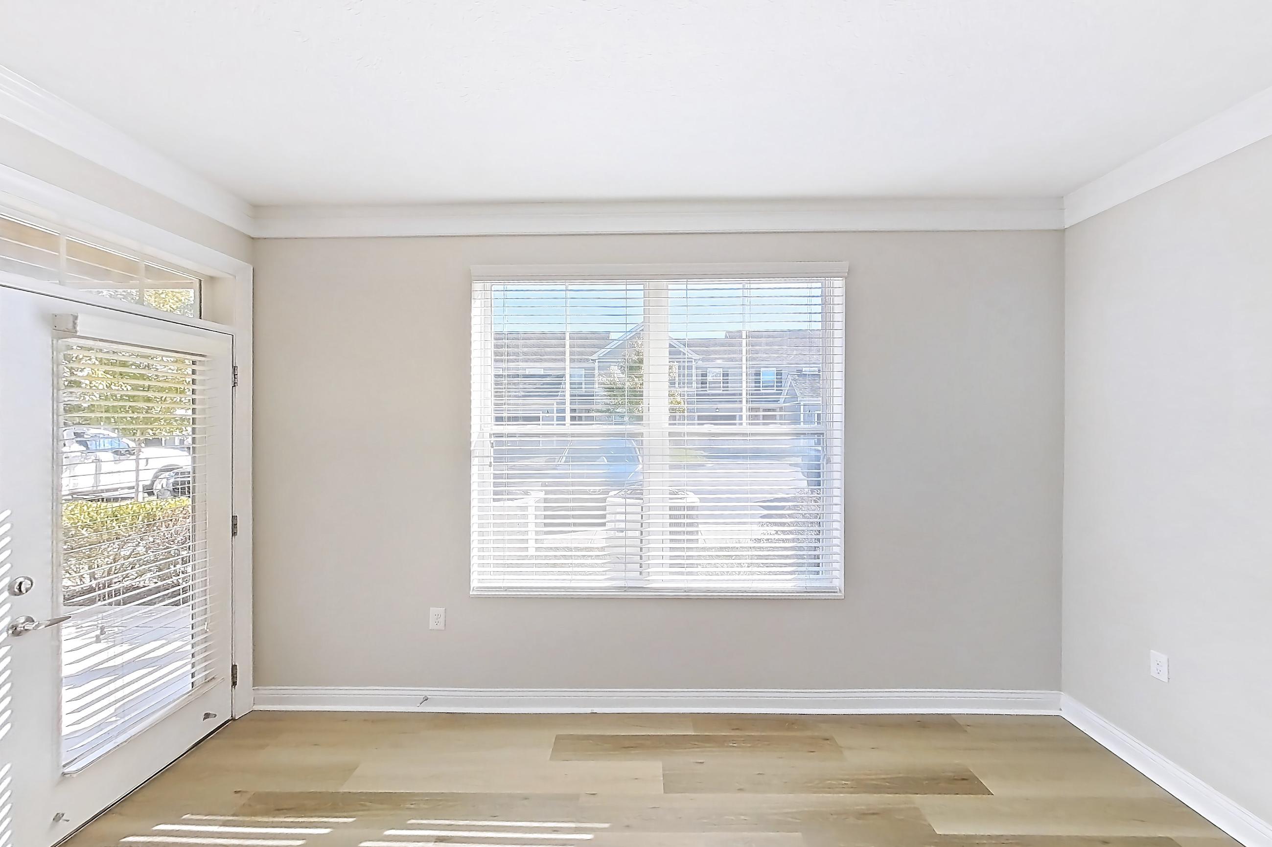 Living room with light wood-finish flooring, Apartment M265 at Cortland Northlake
