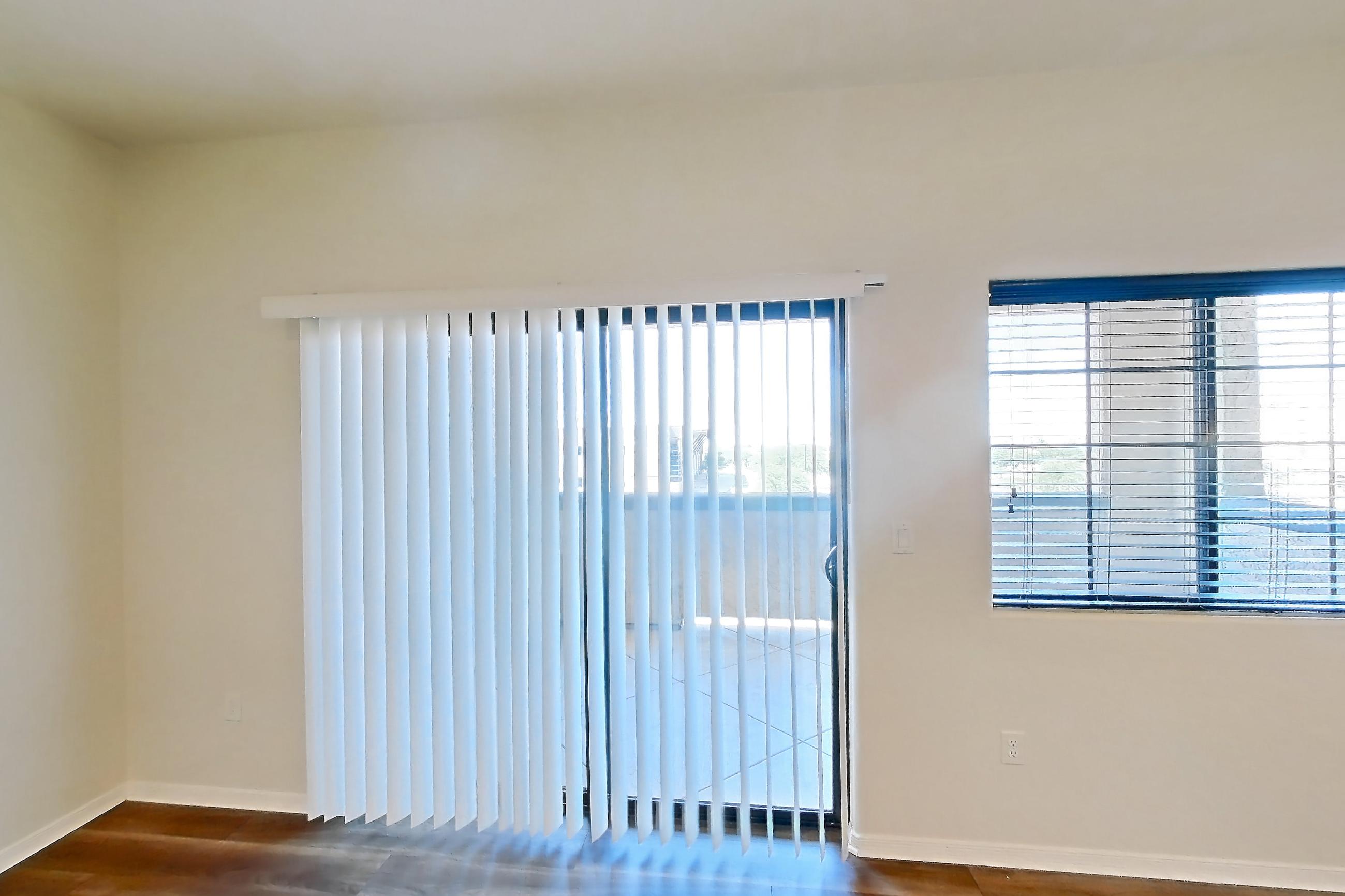 Living room with dark wood-finish flooring, Apartment 01301 at Cortland on the Loop
