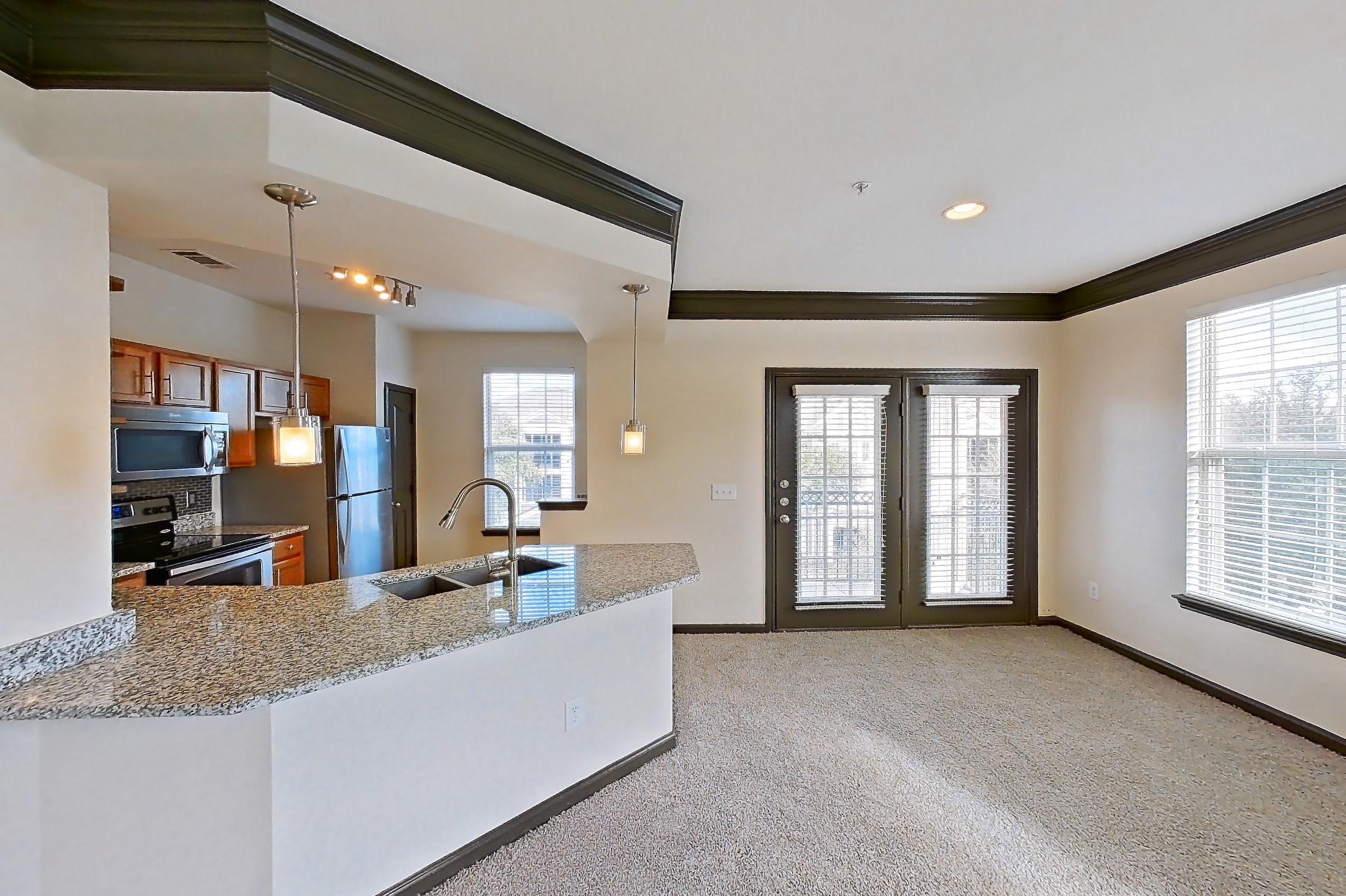 Living room with electric range, light carpet, oven/range, refrigerator, and stainless steel appliances, Apartment 1-939 at Cortland Ridglea