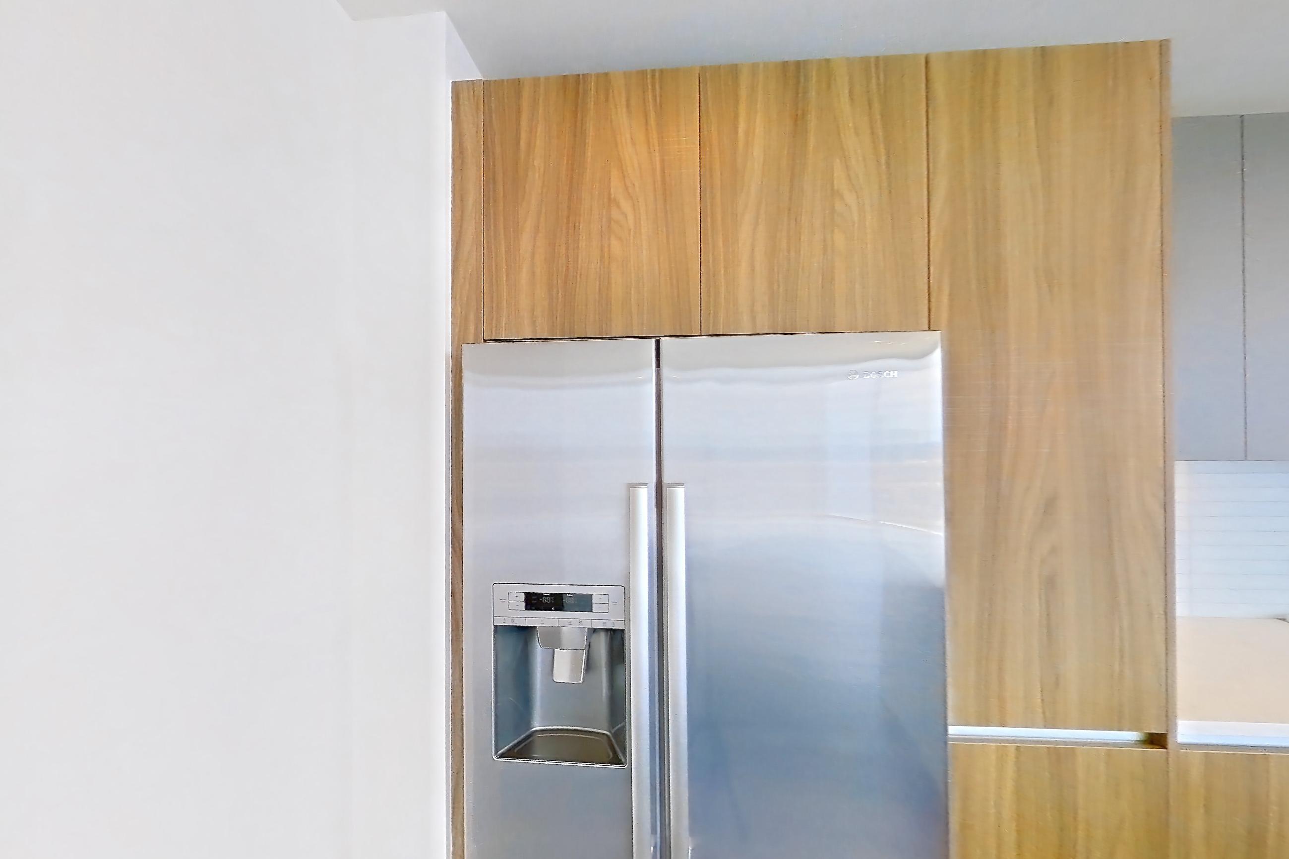 Kitchen space with dark wood-finish flooring, gas range, light countertops, oven/range, refrigerator, stainless steel appliances, and water & ice dispenser, Apartment 2803 at Brava
