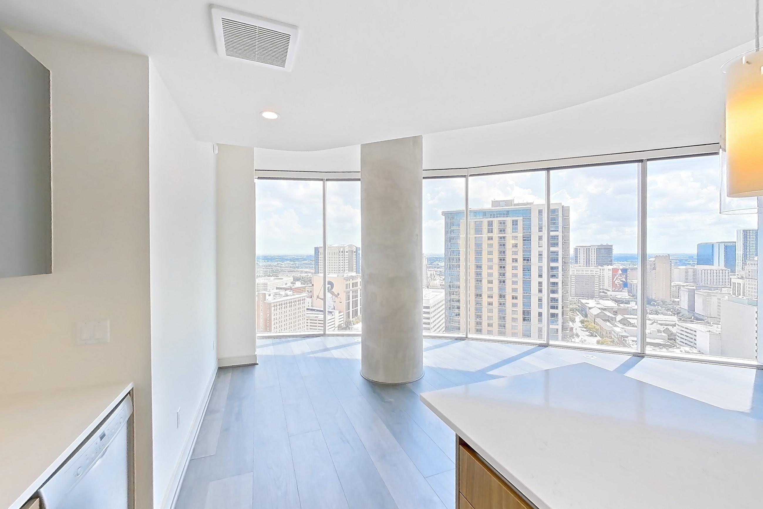 Kitchen with dark wood-finish flooring, gas range, light stone countertops, oven/range, and stainless steel appliances, Apartment 2803 at Brava