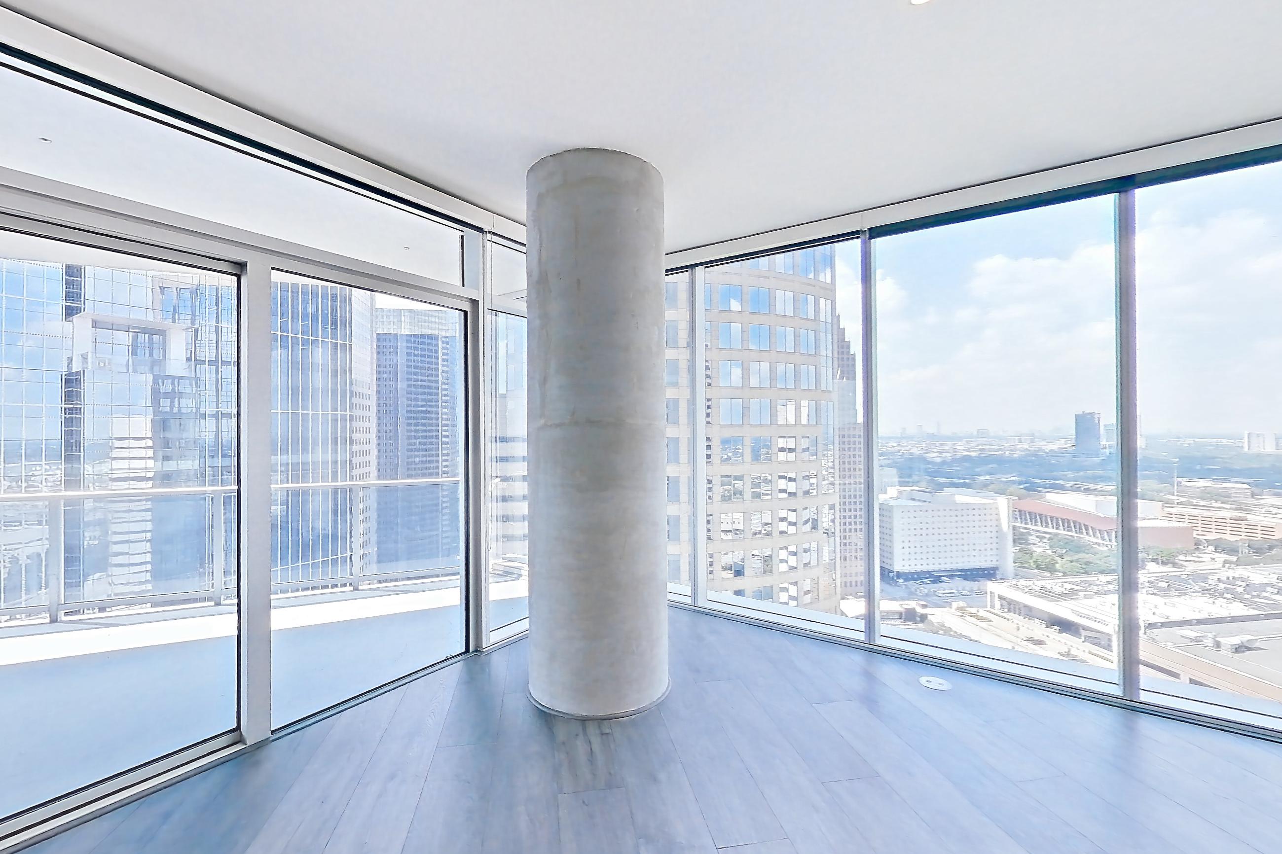 Living room with city view, dark wood-finish flooring, gas range, light stone countertops, oven/range, and stainless steel appliances, Apartment 3102 at Brava