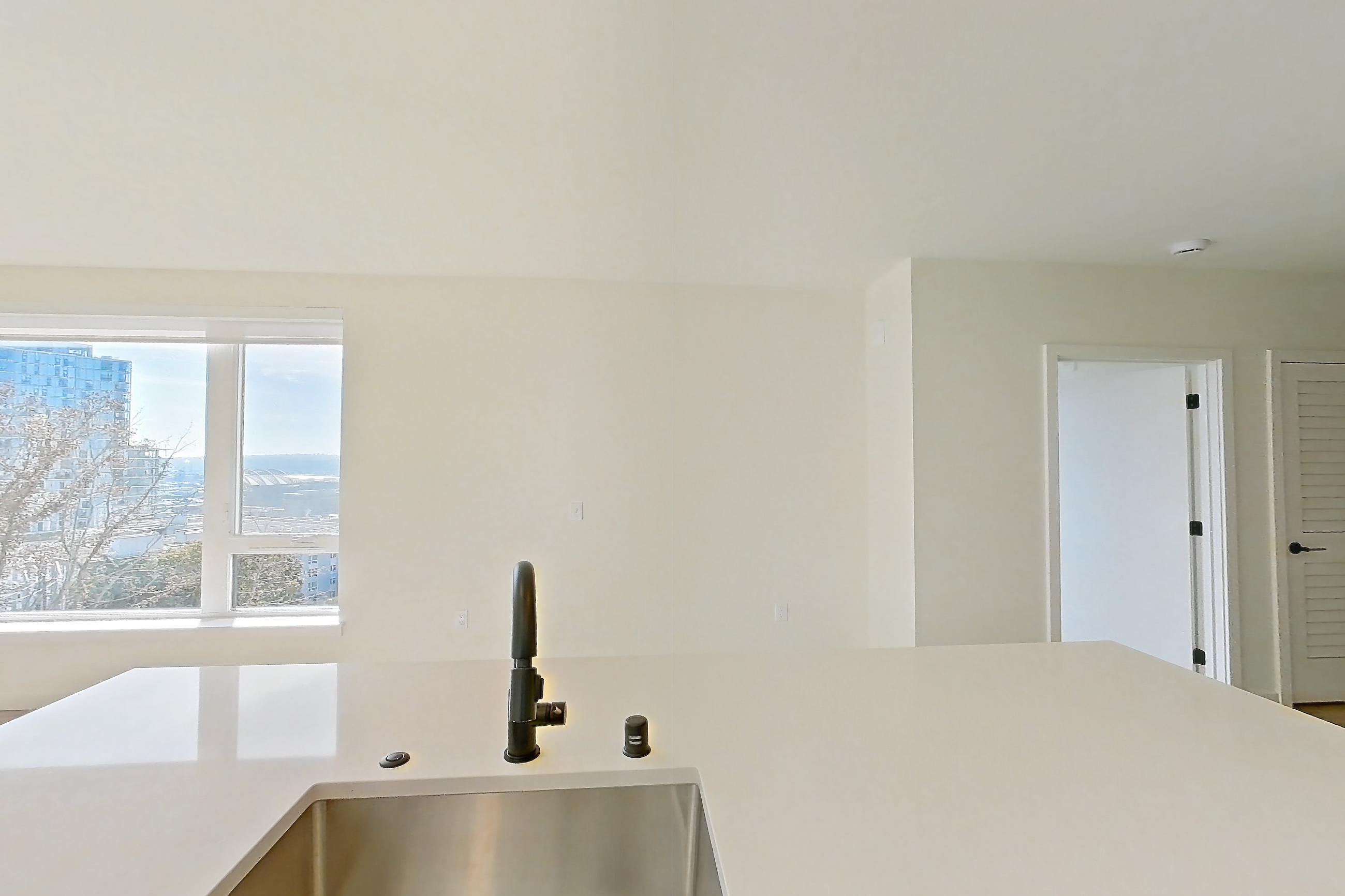 Kitchen with dishwasher, electric range, light countertops, light wood-finish flooring, oven/range, refrigerator, and stainless steel appliances, Apartment 743 at Cascara
