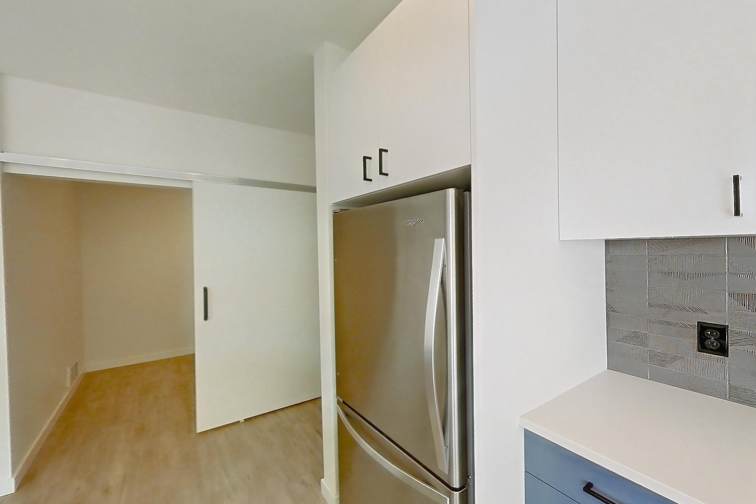 Kitchen with dishwasher, electric range, light countertops, light wood-finish flooring, oven/range, refrigerator, and stainless steel appliances, Apartment 743 at Cascara