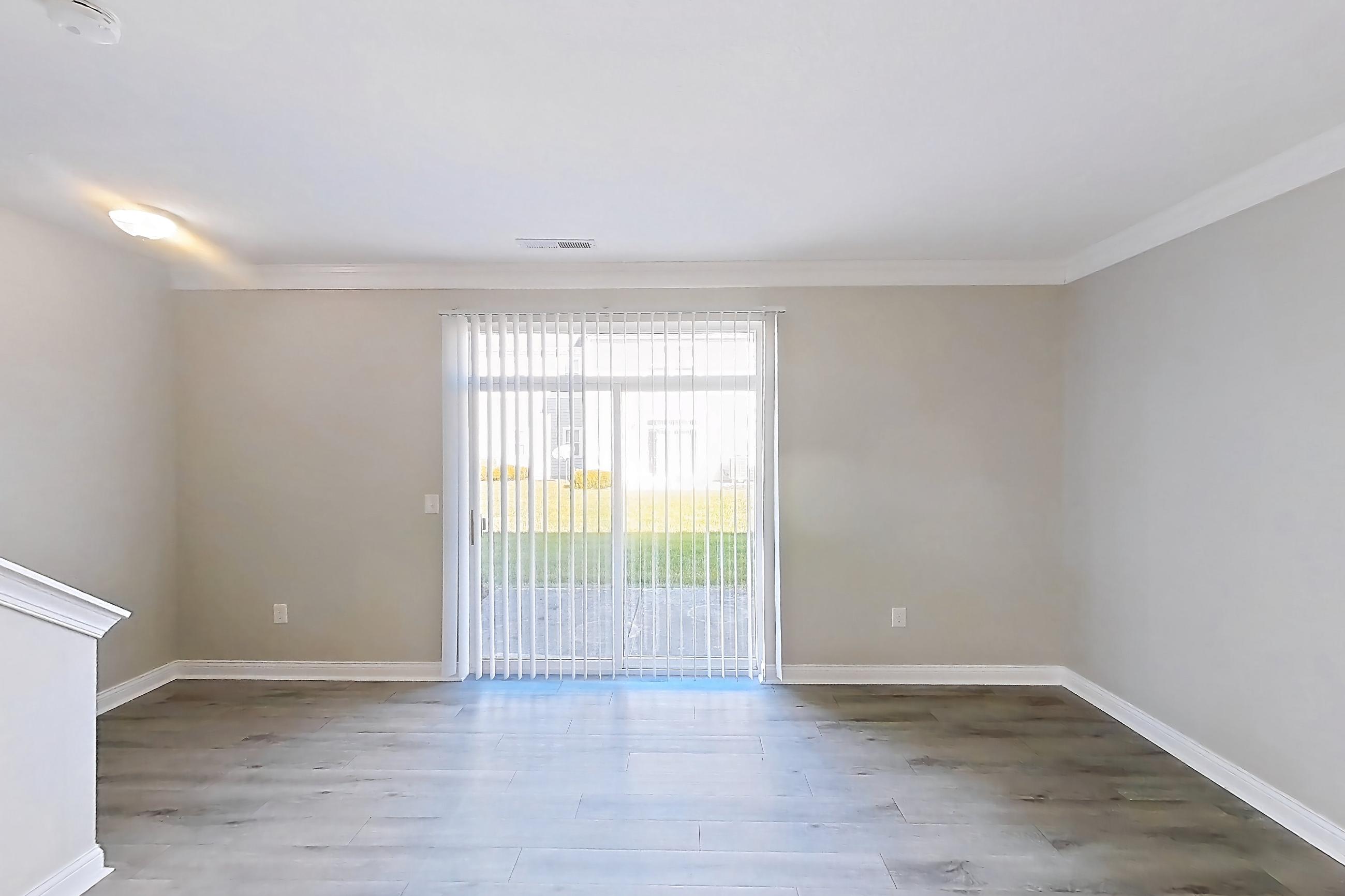 Living room with light wood-finish flooring, Apartment C3318 at Cortland Powell