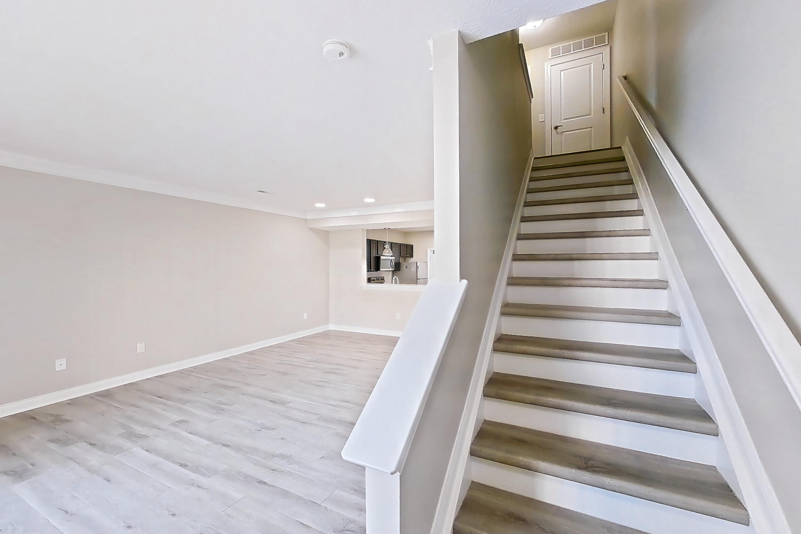 Living space with light wood-finish flooring, Apartment C3318 at Cortland Powell