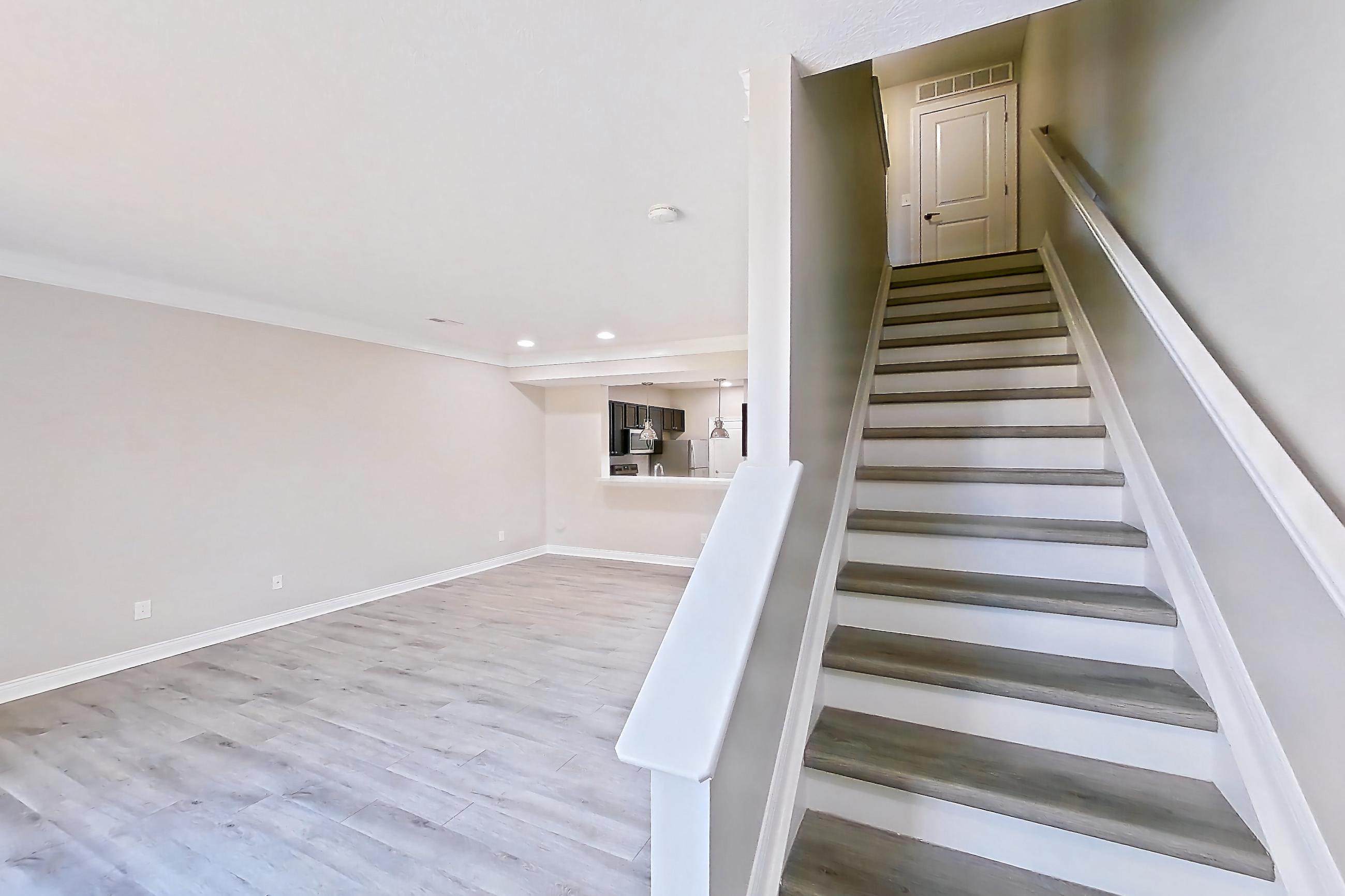 Living space with light wood-finish flooring, Apartment H9045 at Cortland Powell