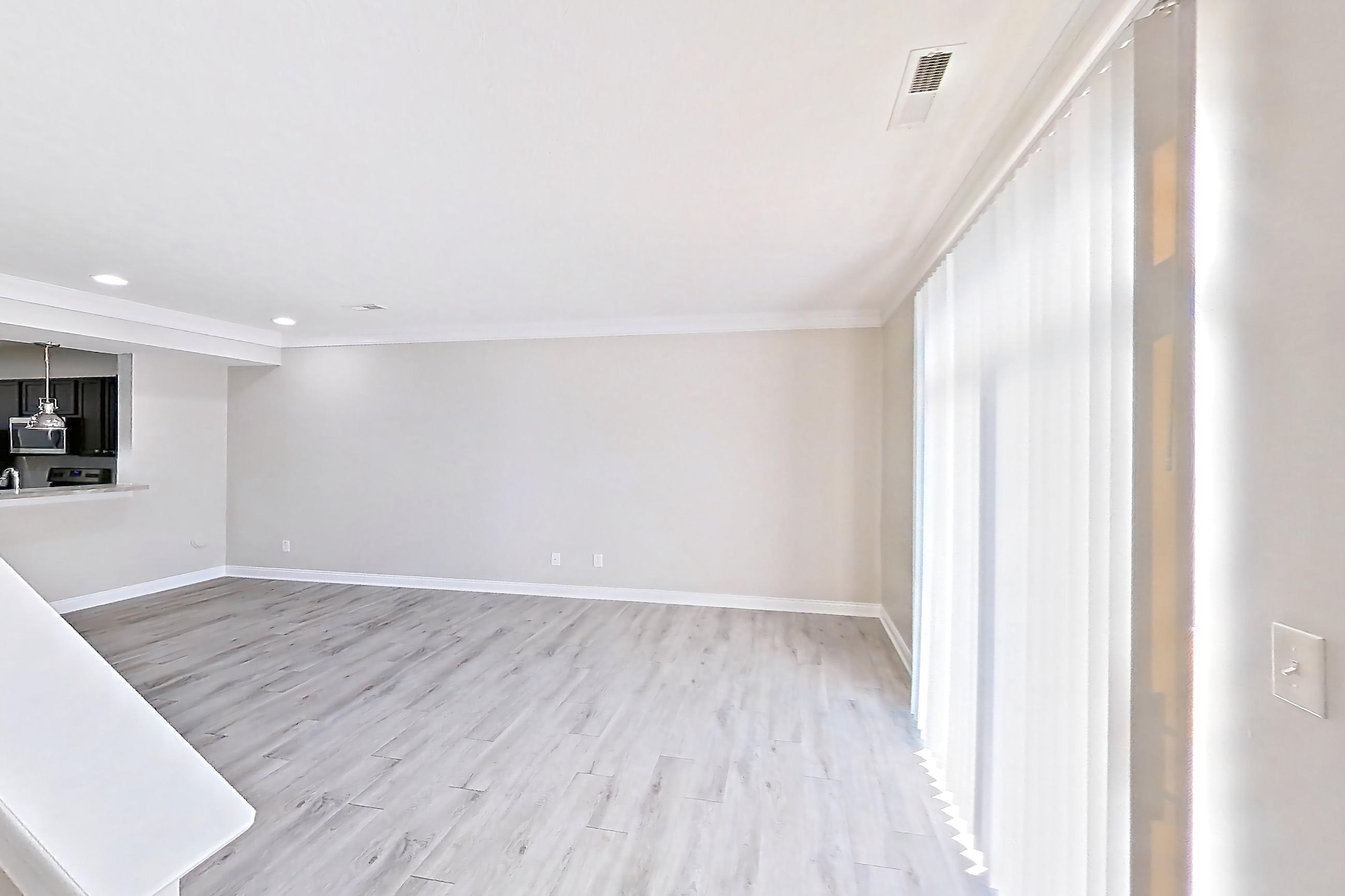 Living space with light wood-finish flooring, Apartment M3271 at Cortland Powell