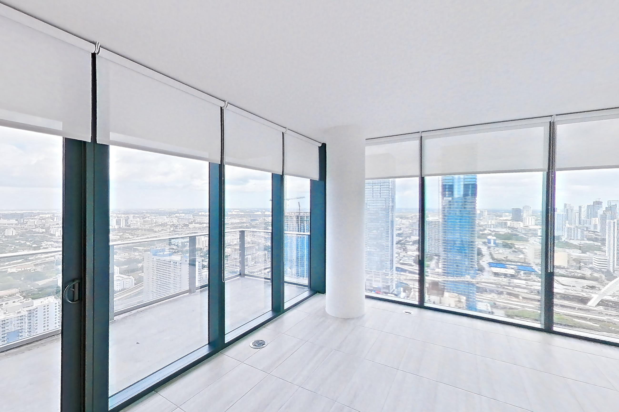Living room with city view and light tile flooring, Apartment 5201 at Miami World Tower