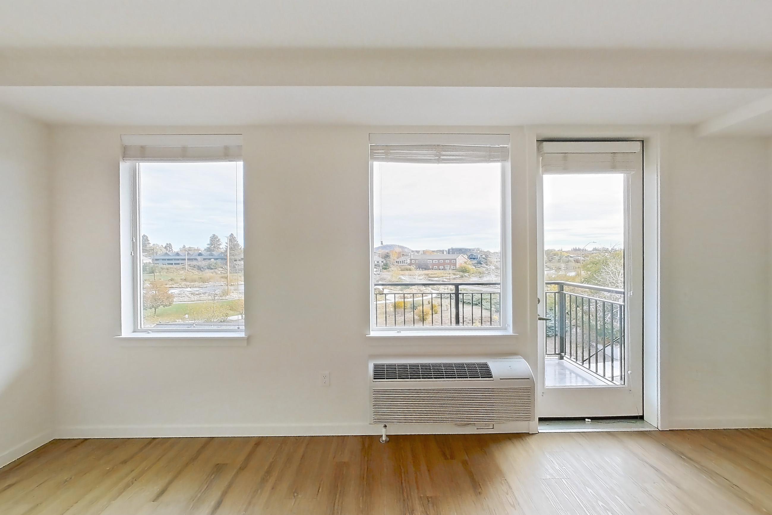 Living room with air conditioning and light wood-finish flooring, Apartment 249 at The Eddy Apartments