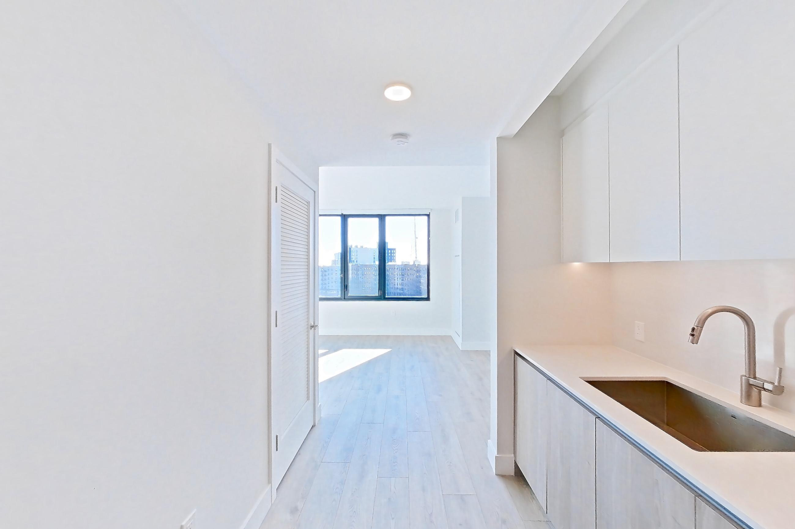 Kitchen with gas range, light wood-finish flooring, oven/range, and stainless steel appliances, Apartment 0535 at Loden