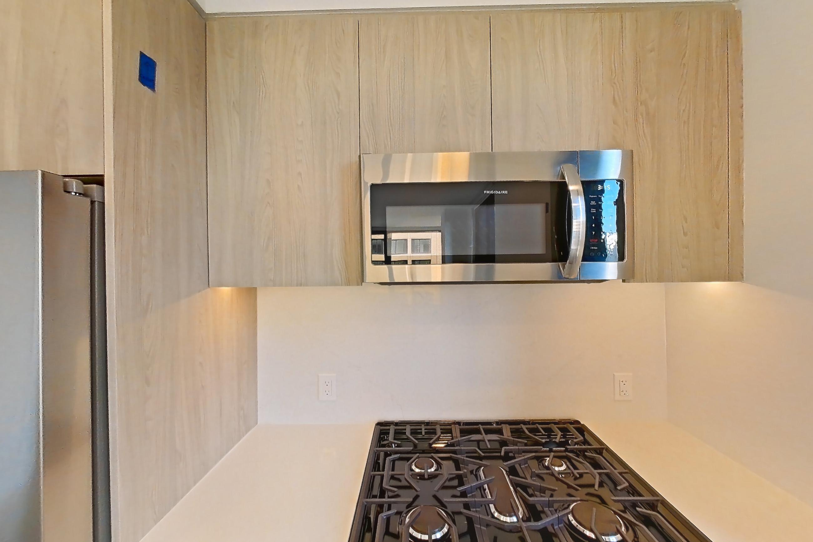 Kitchen with gas range, light wood-finish flooring, oven/range, and stainless steel appliances, Apartment 0638 at Loden