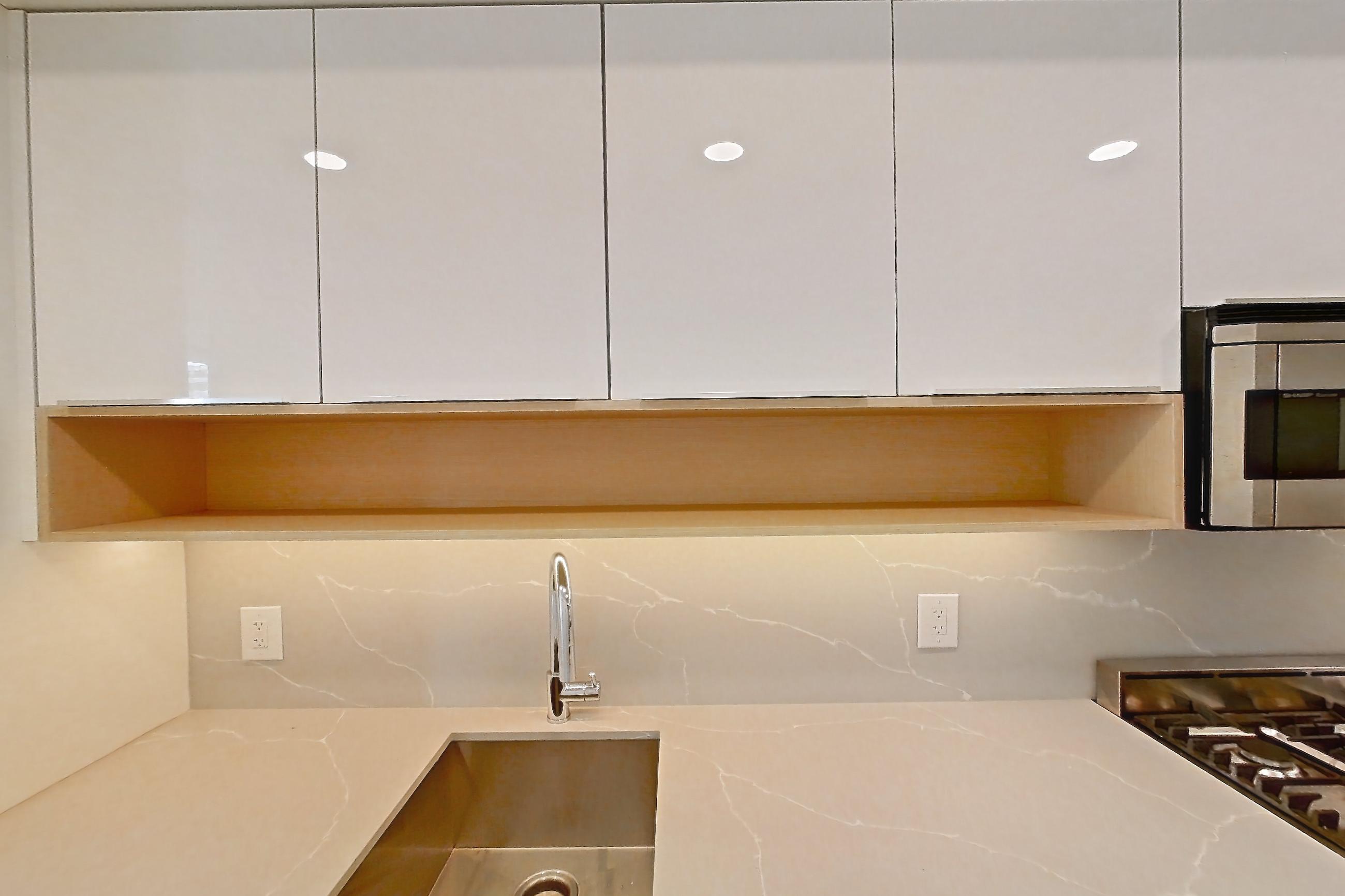 Kitchen with gas range, light stone countertops, light wood-finish flooring, oven/range, and stainless steel appliances, Apartment 2406 at 20 Broad