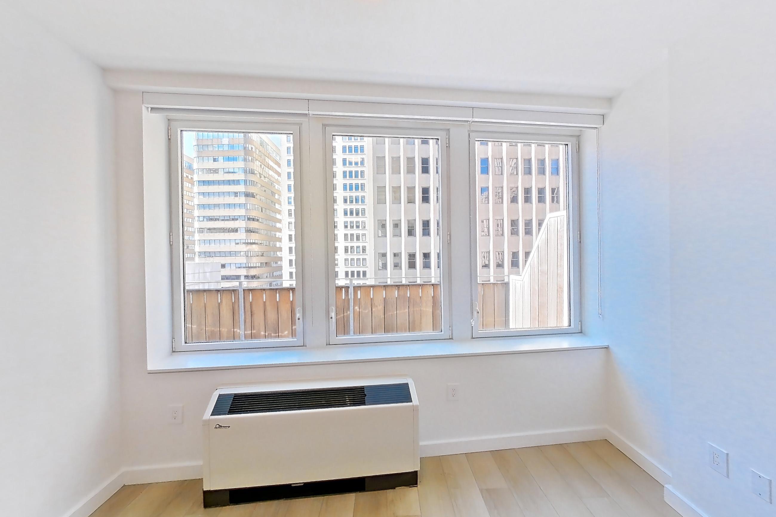 Living room with air conditioning and light wood-finish flooring, Apartment 2406 at 20 Broad