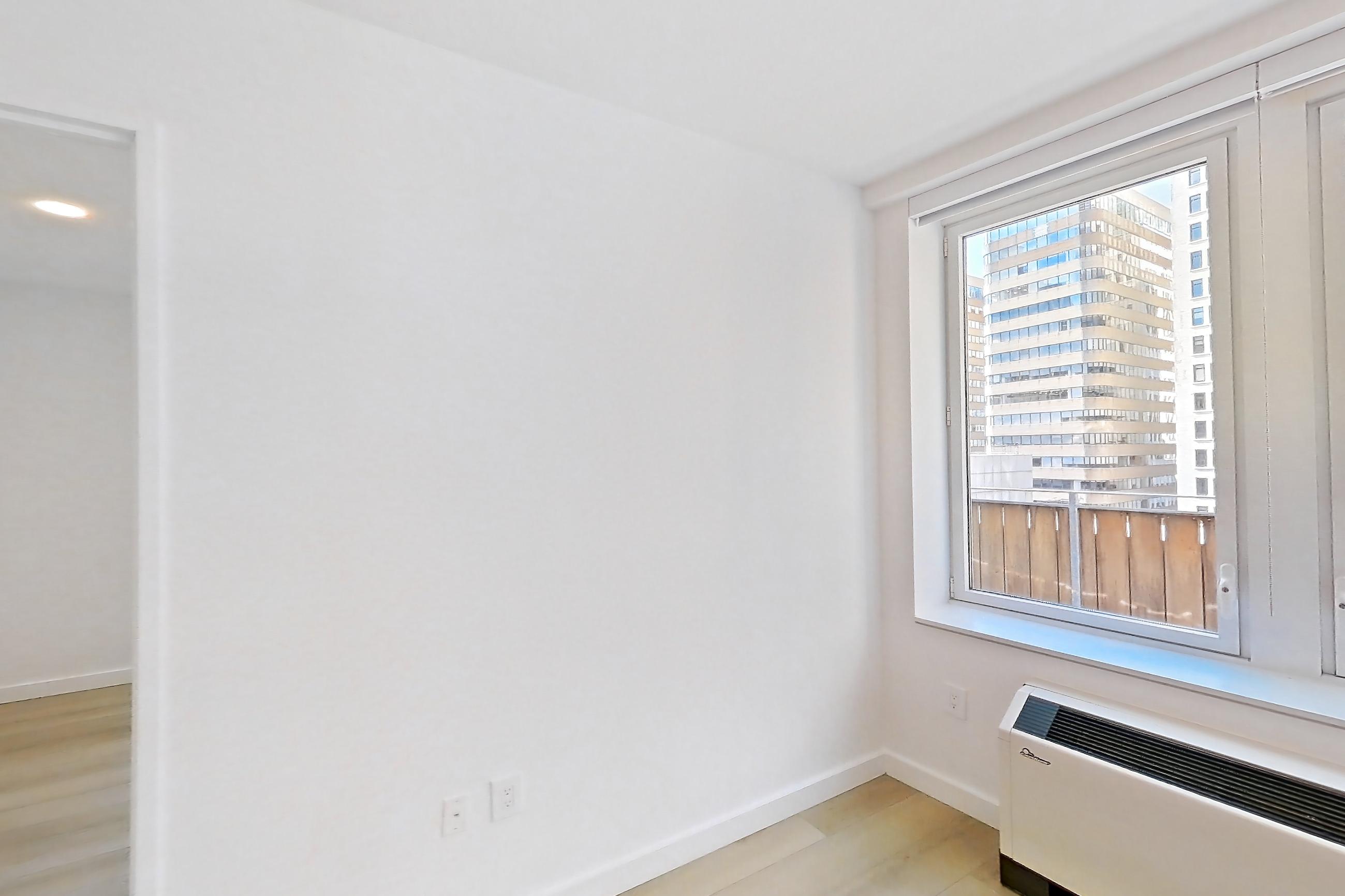 Living room with air conditioning and light wood-finish flooring, Apartment 2406 at 20 Broad