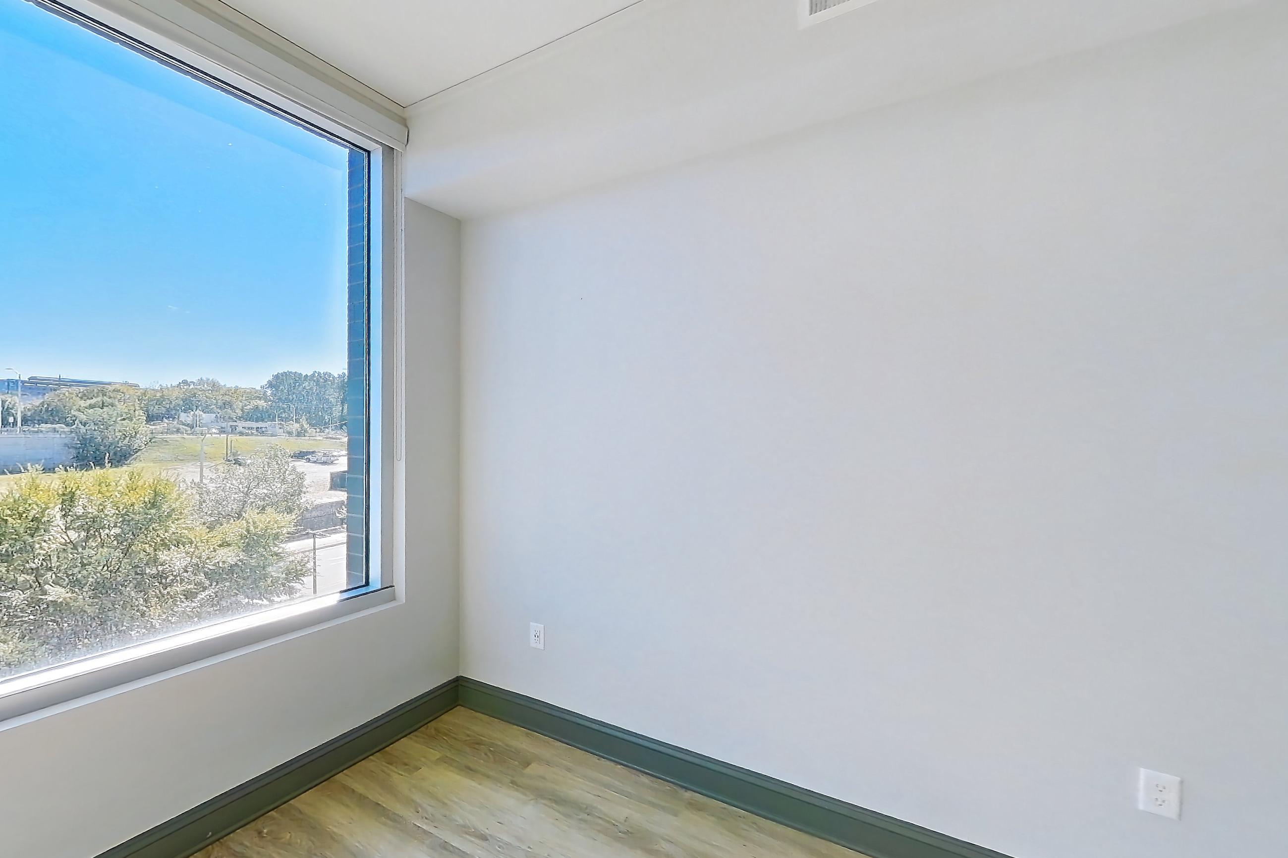 Living room with light wood-finish flooring, Apartment 234 at Cortland Glenwood South