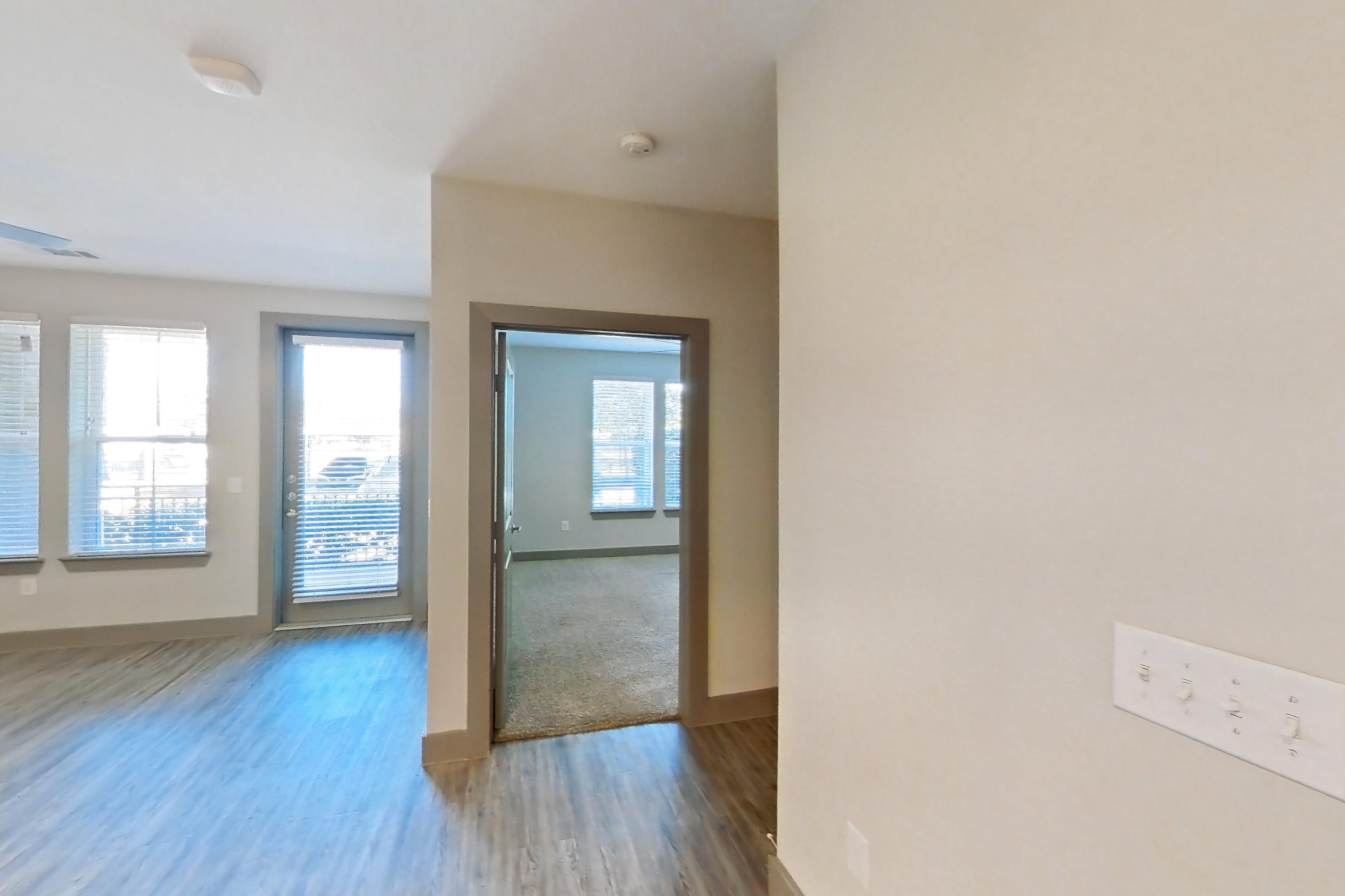Dining room with electric range, light stone countertops, light wood-finish flooring, microwave, oven/range, and stainless steel appliances, Apartment 05103 at Embree Hill