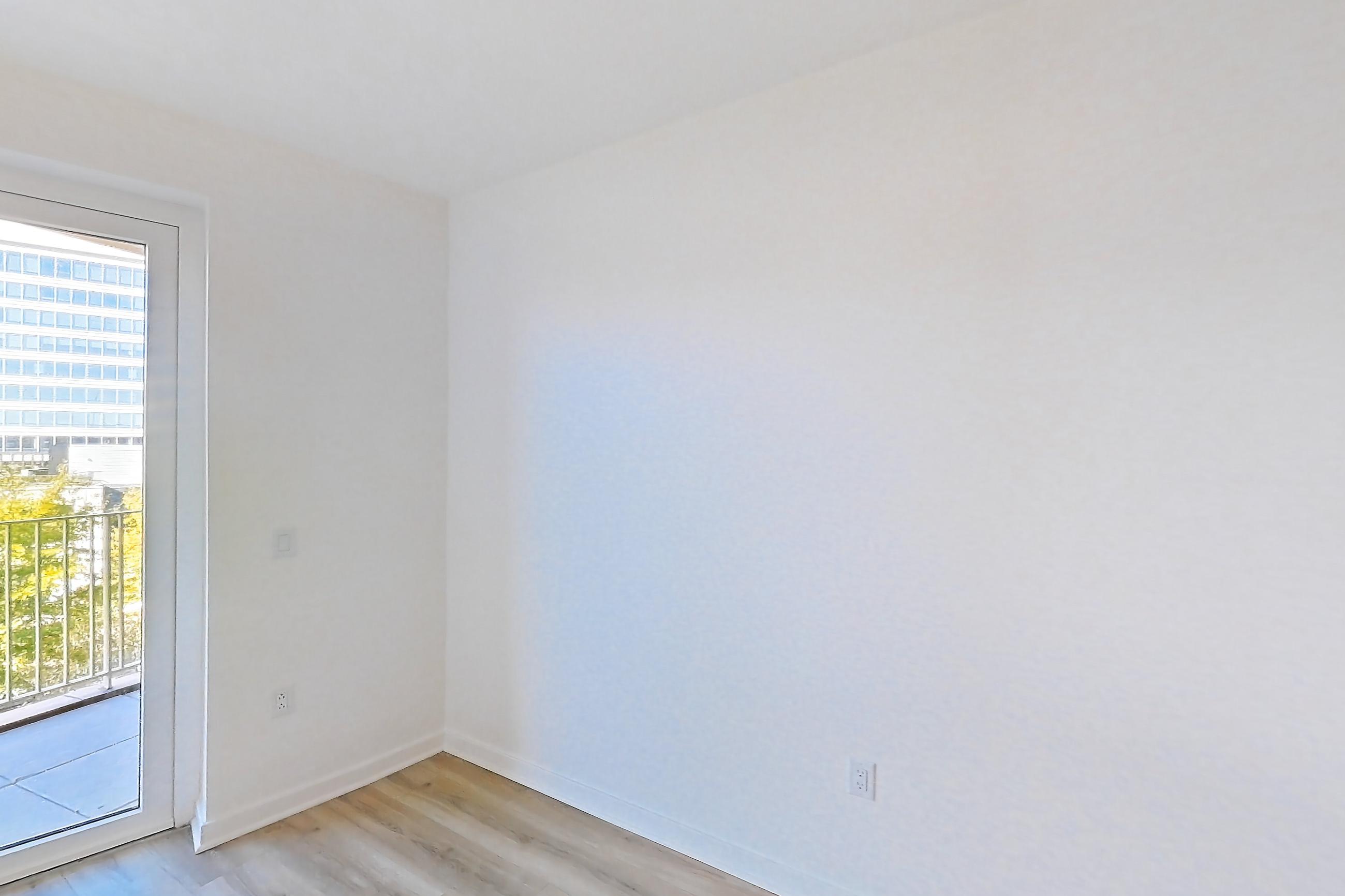 Living room with light wood-finish flooring, Apartment 416 at Residences at Mazza