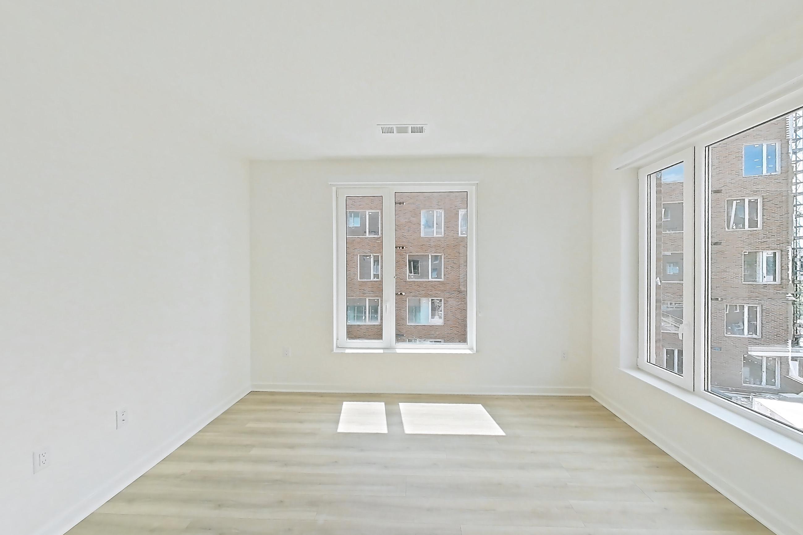 Living room with light wood-finish flooring, Apartment 303 at Residences at Mazza