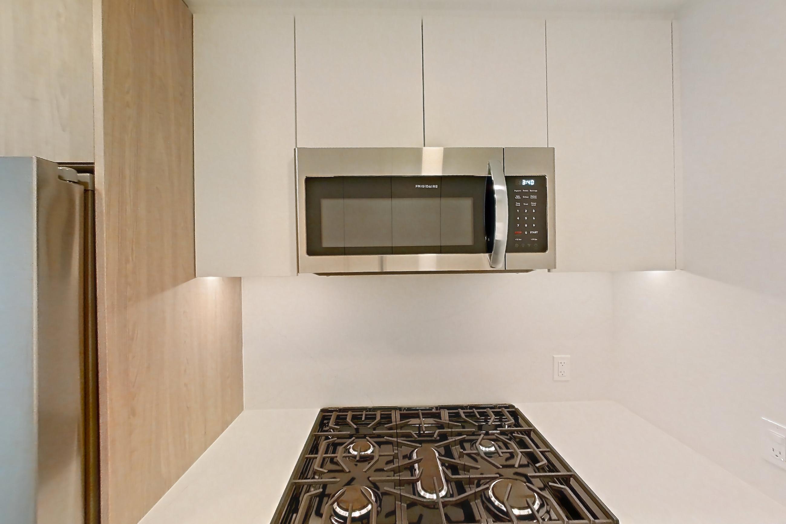 Kitchen with gas range, light wood-finish flooring, oven/range, and stainless steel appliances, Apartment 737 at Loden